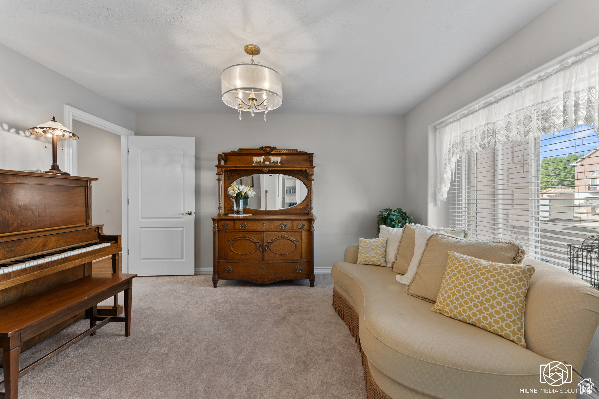 Living room featuring an inviting chandelier and light carpet