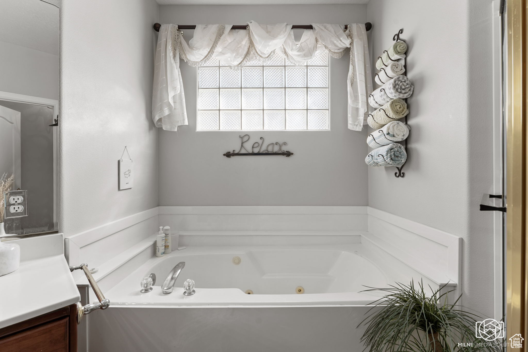 Bathroom featuring a tub to relax in and vanity