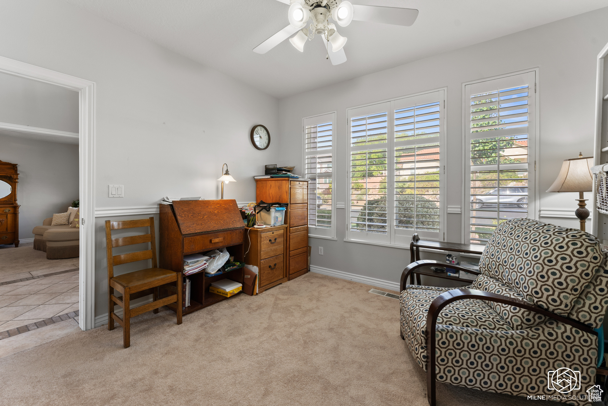 Office space featuring light carpet and ceiling fan