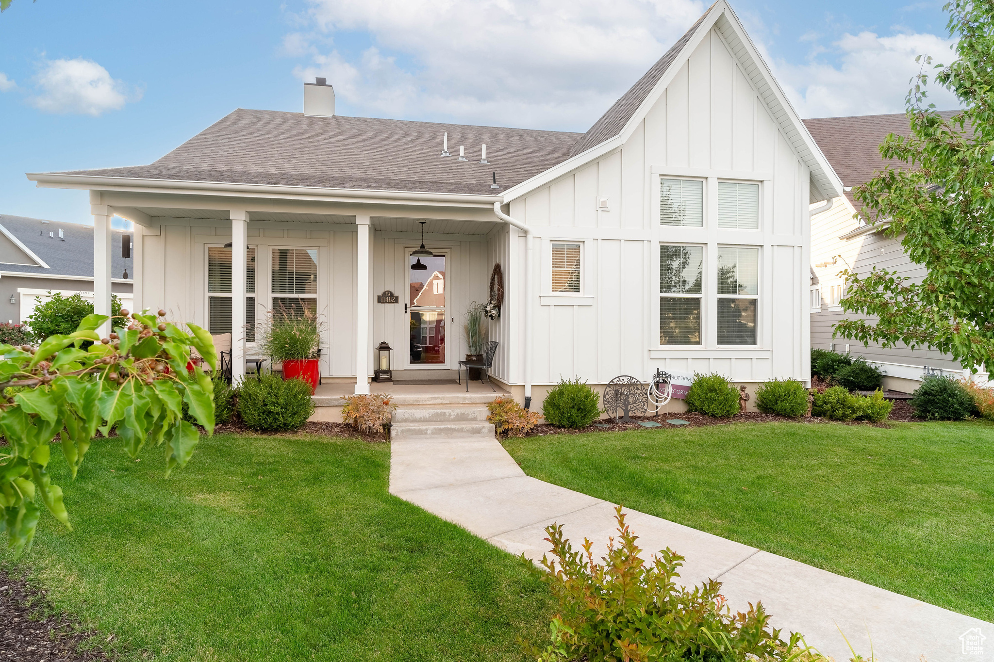 View of front facade featuring covered porch and a front yard