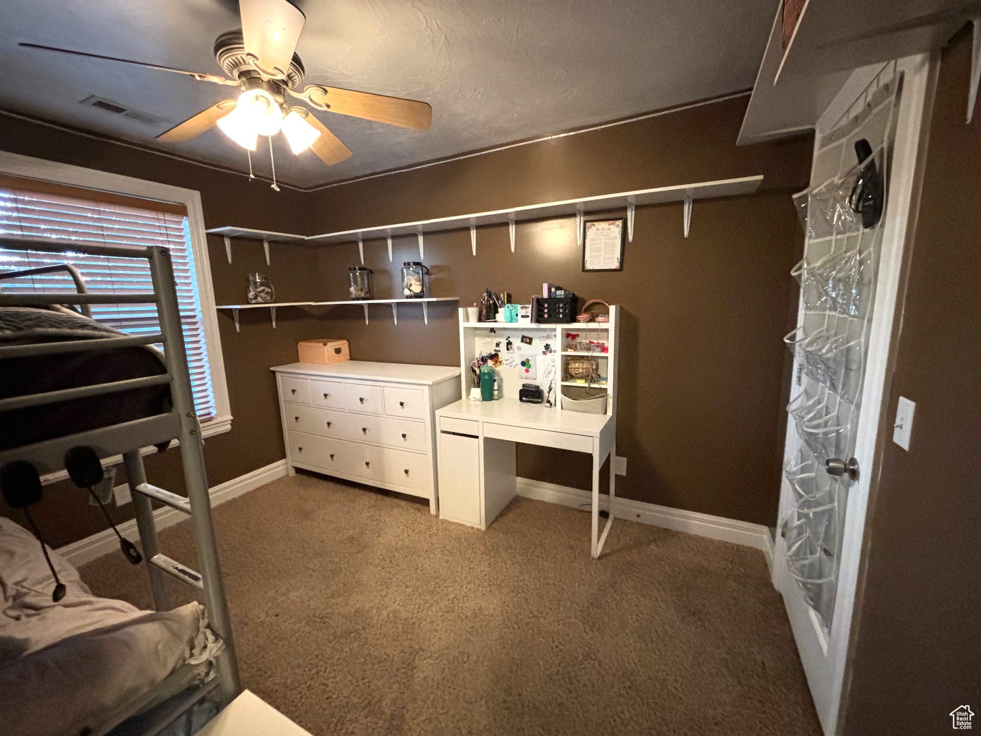 Carpeted bedroom with ceiling fan