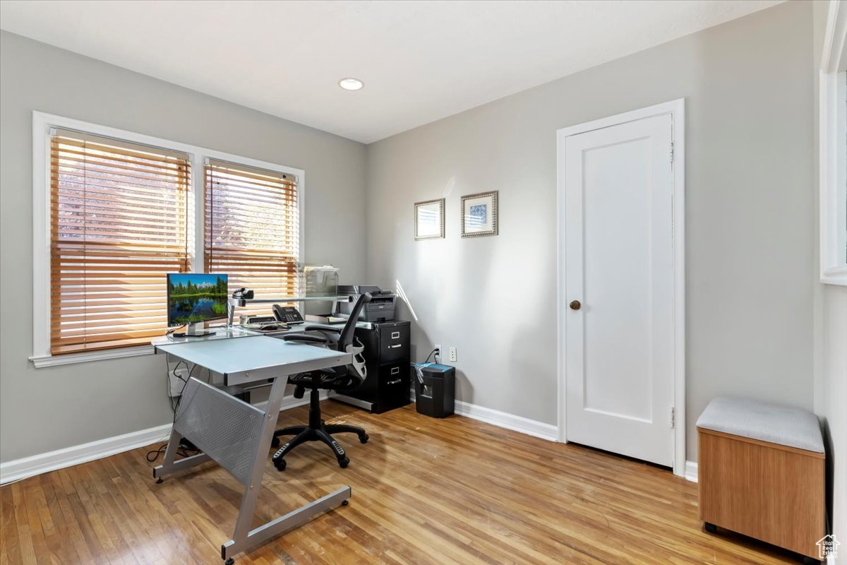 Office area with light wood-type flooring