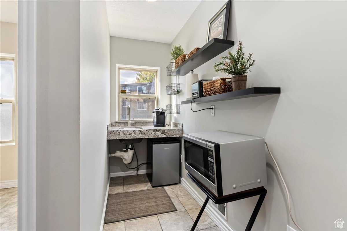 Interior space featuring tile patterned flooring and sink