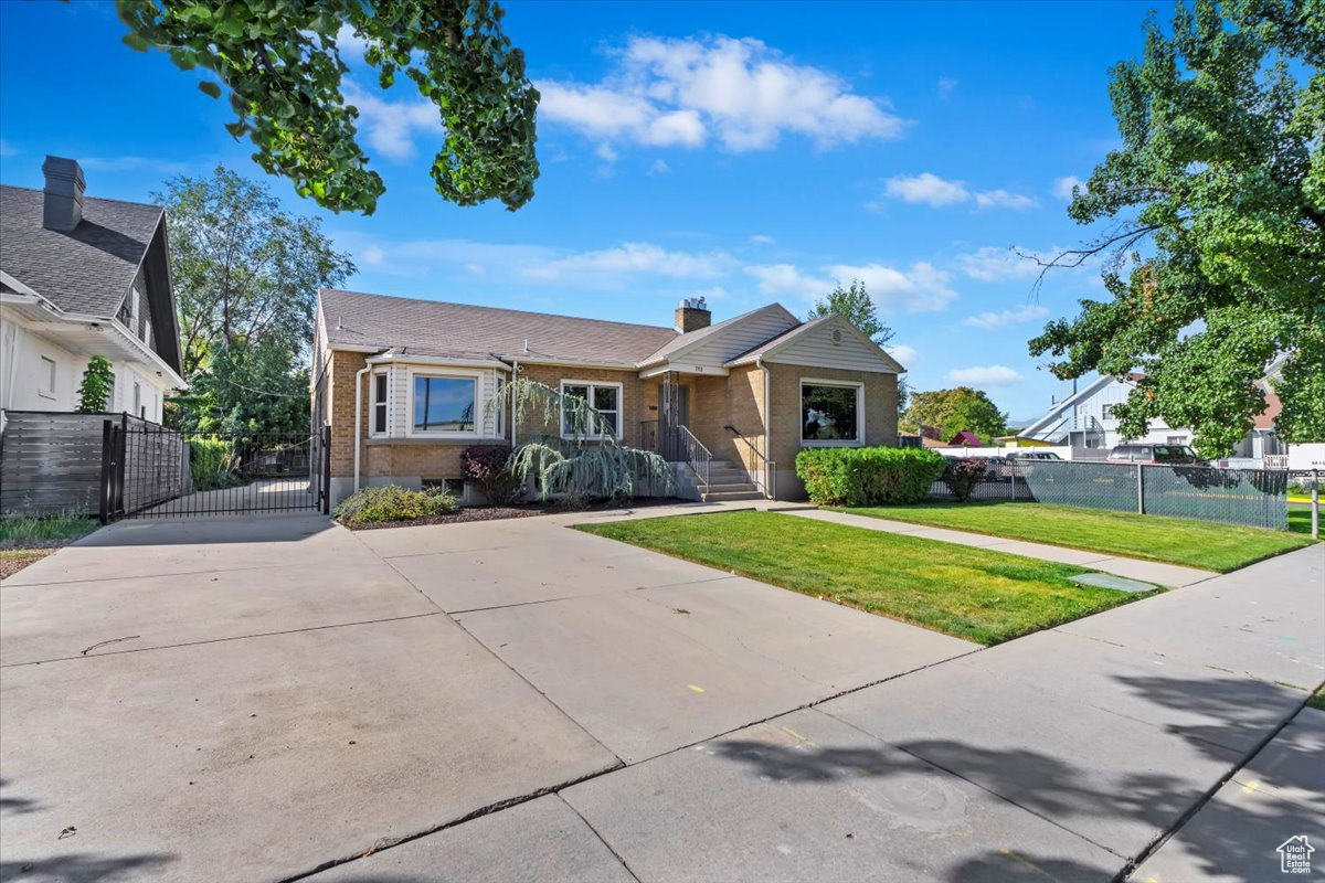 Bungalow-style house with a front lawn