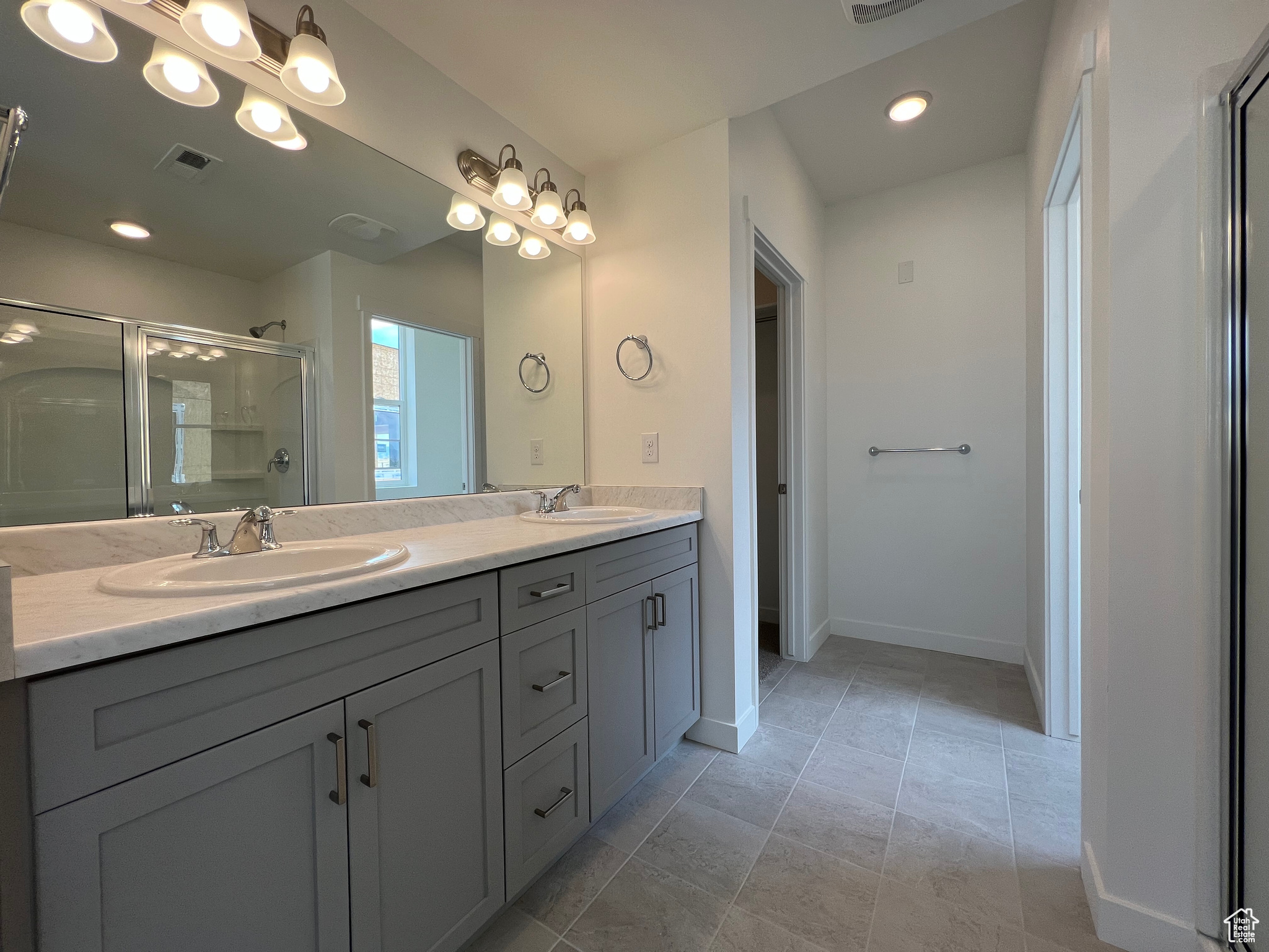 Bathroom featuring vanity and an enclosed shower