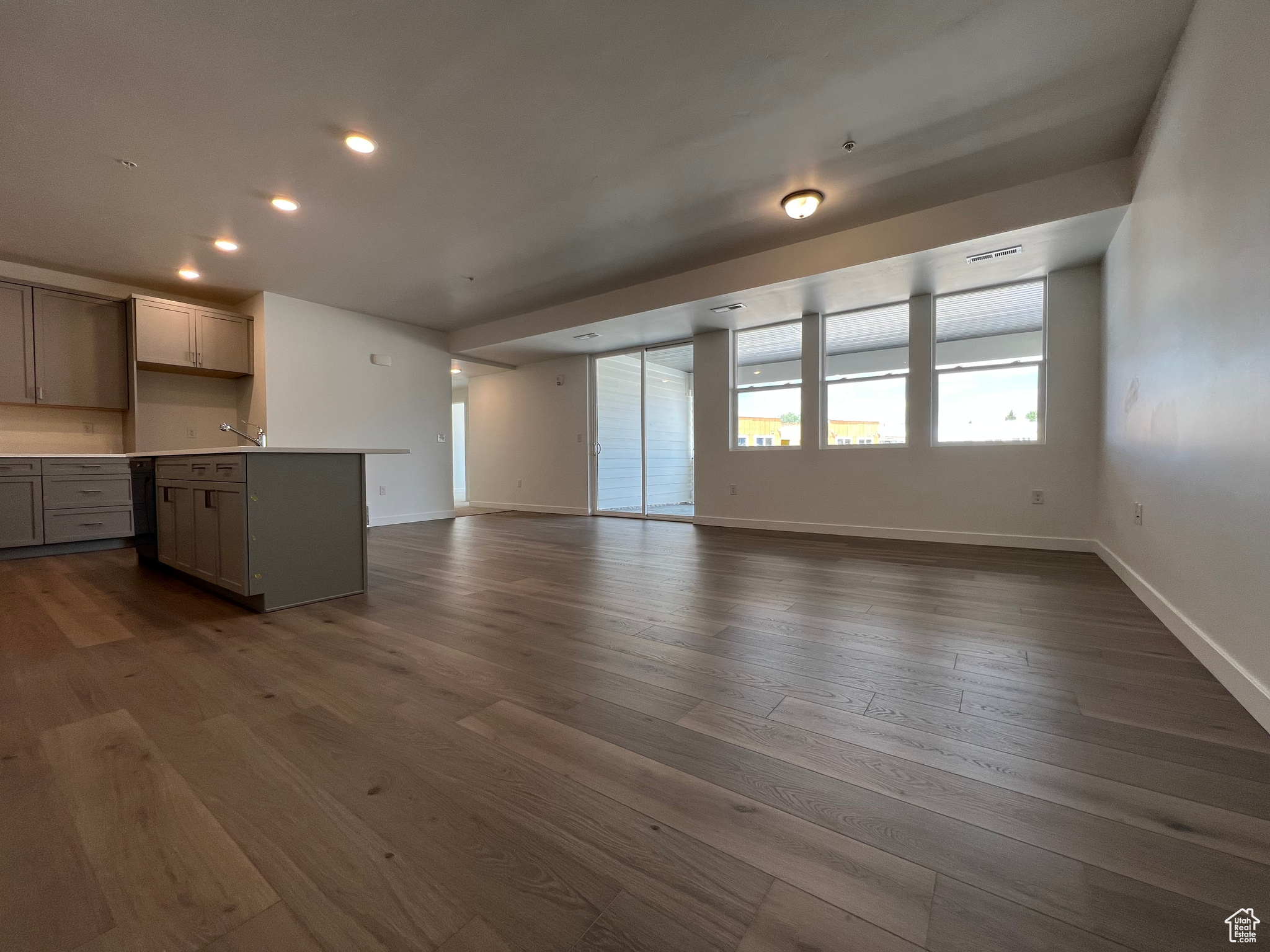 Unfurnished living room with dark wood-type flooring