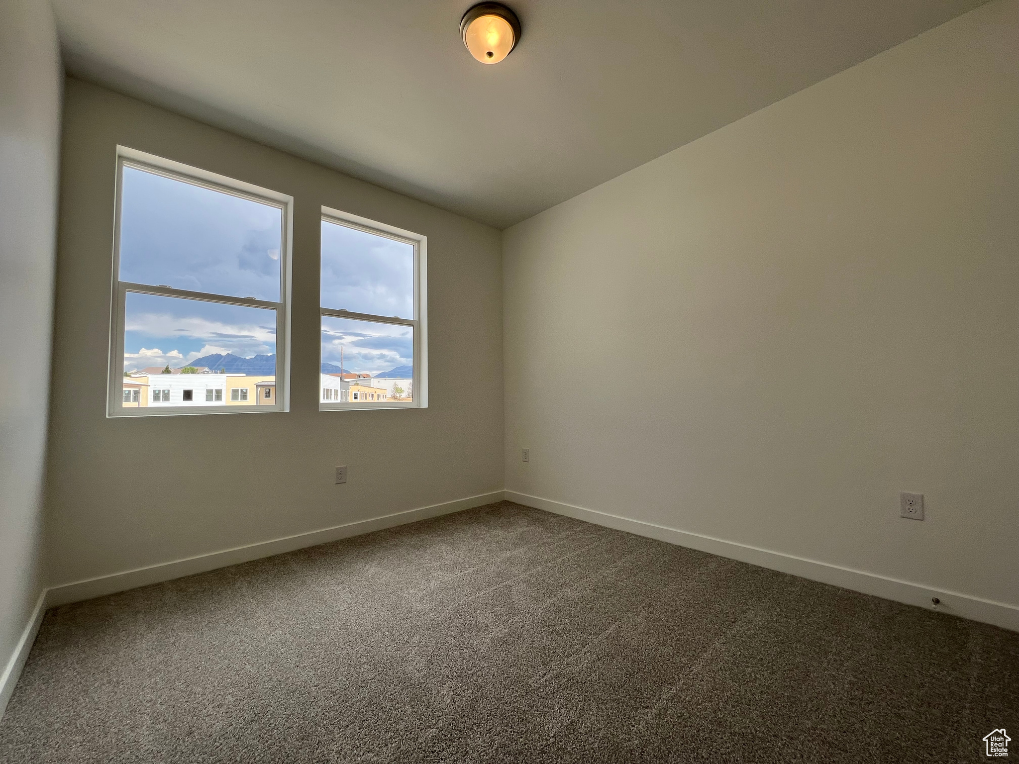 Unfurnished room with carpet