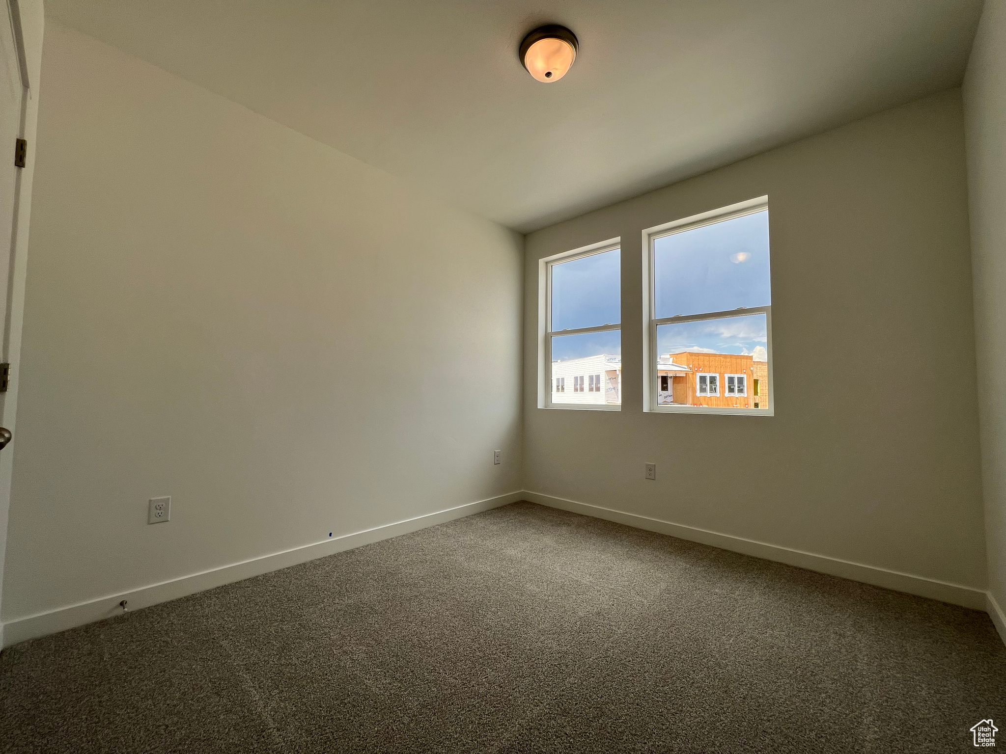 Unfurnished room with carpet