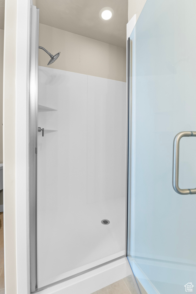 Bathroom featuring walk in shower and tile patterned floors