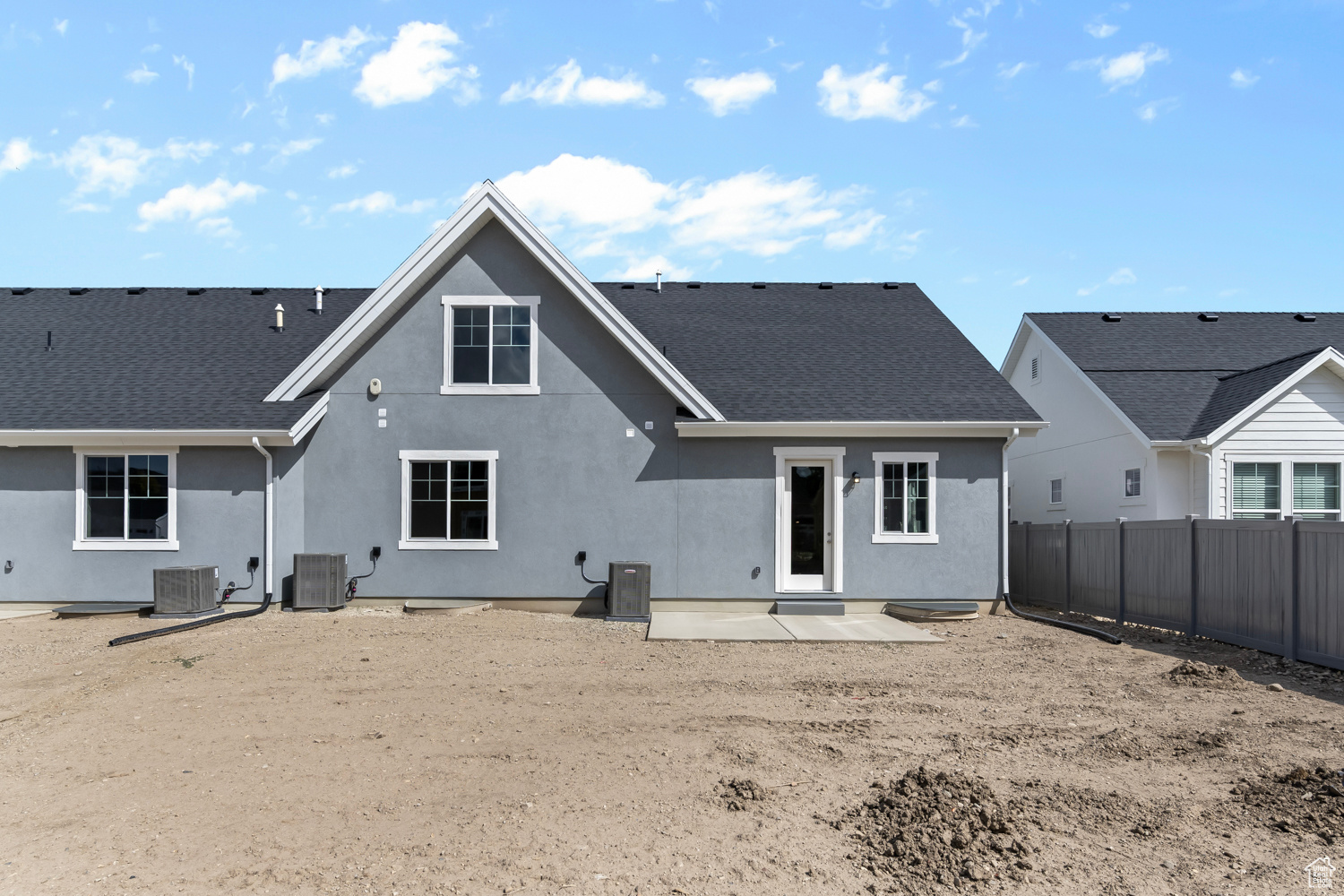 Rear view of property with central AC