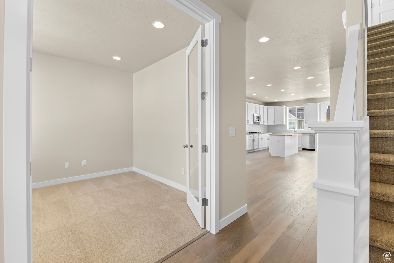 Hall with light wood-type flooring and sink