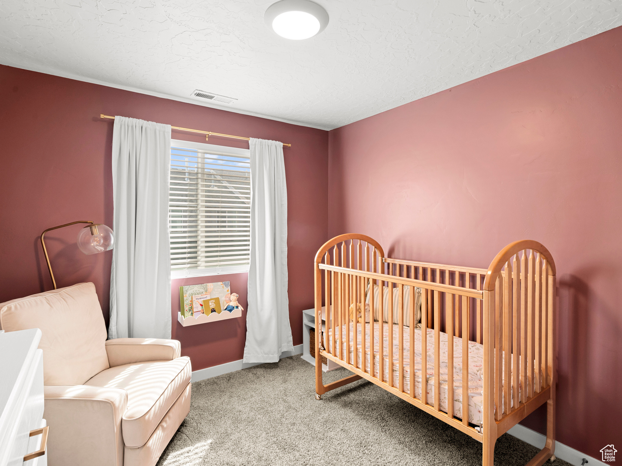 Bedroom featuring a textured ceiling and carpet