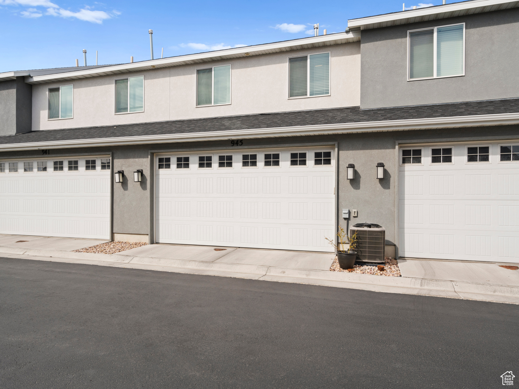 View of front of property with cooling unit and a garage