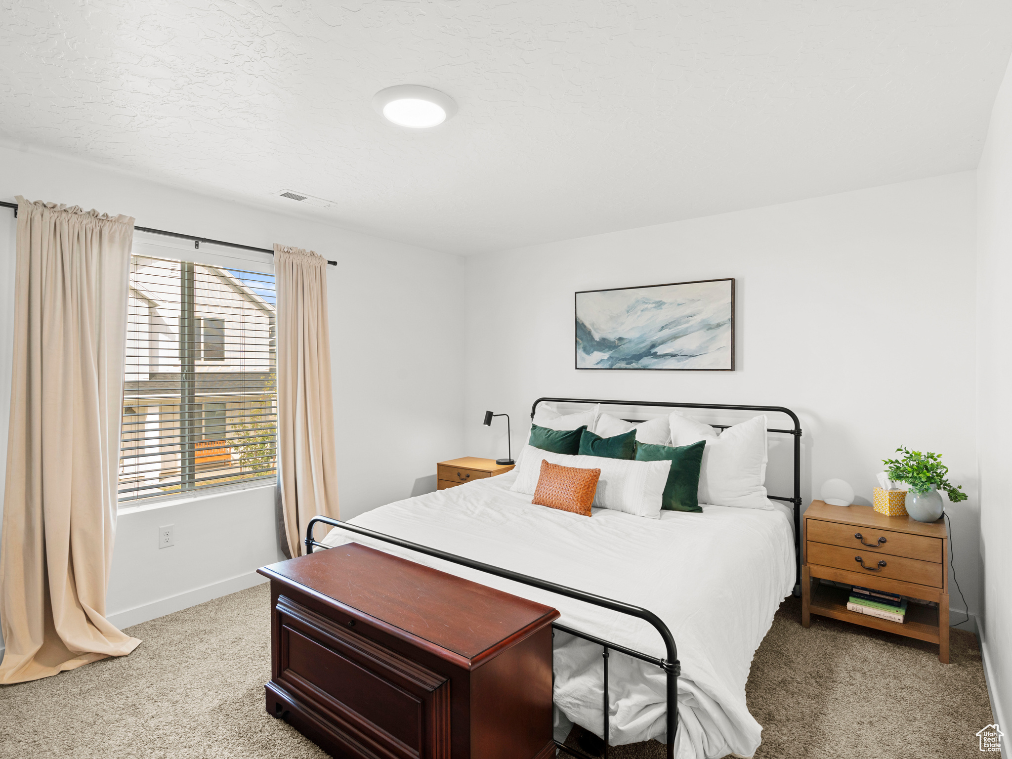 Carpeted bedroom with a textured ceiling