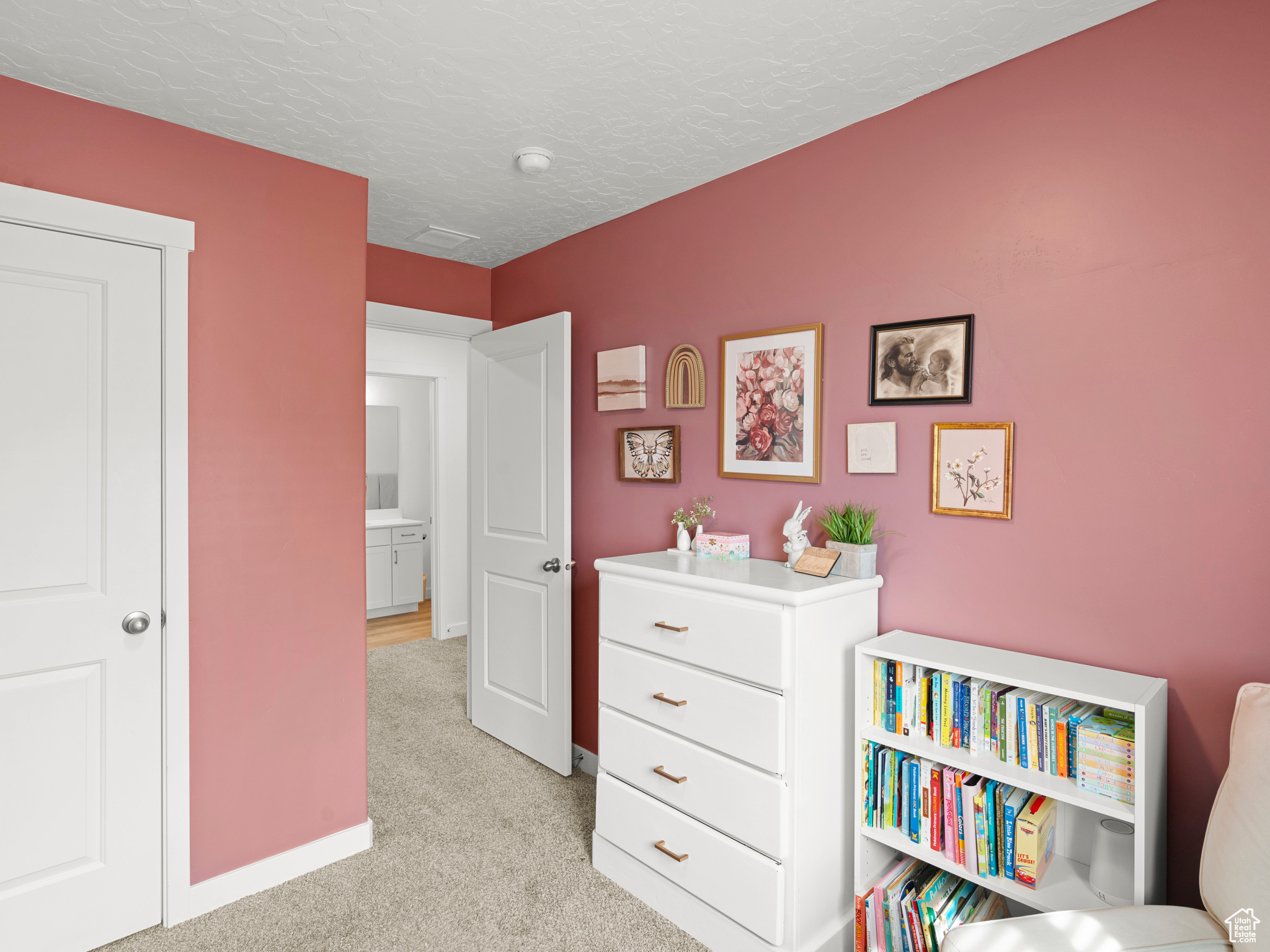 Bedroom with light carpet and a textured ceiling