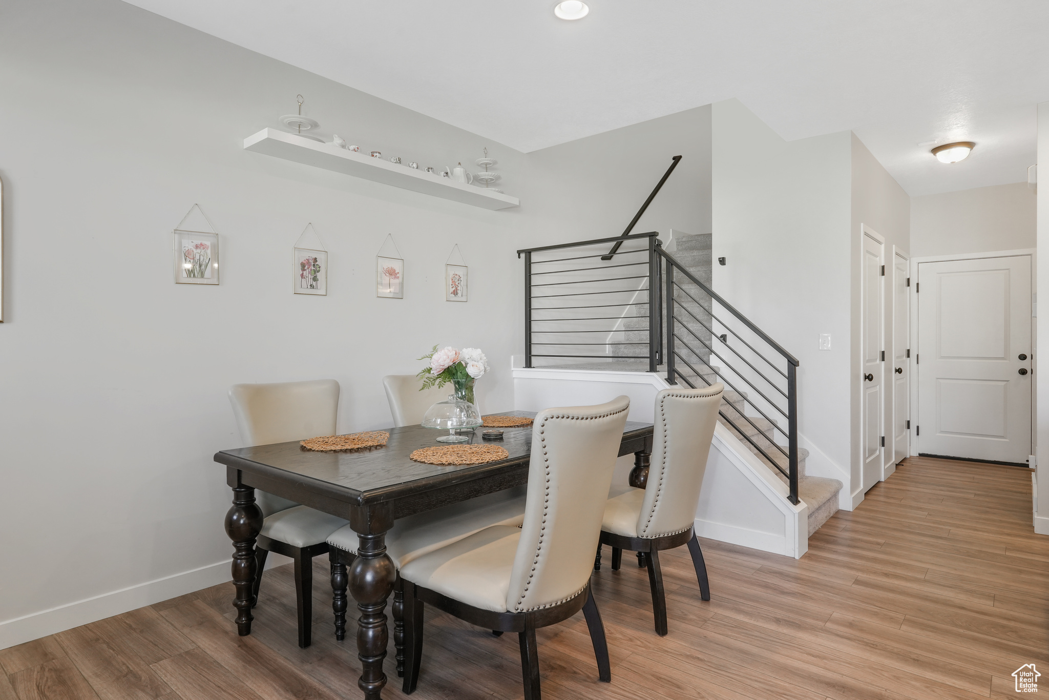 Dining space with light hardwood / wood-style floors