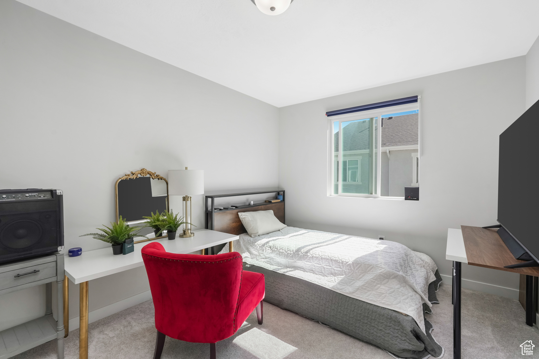 Bedroom featuring light carpet