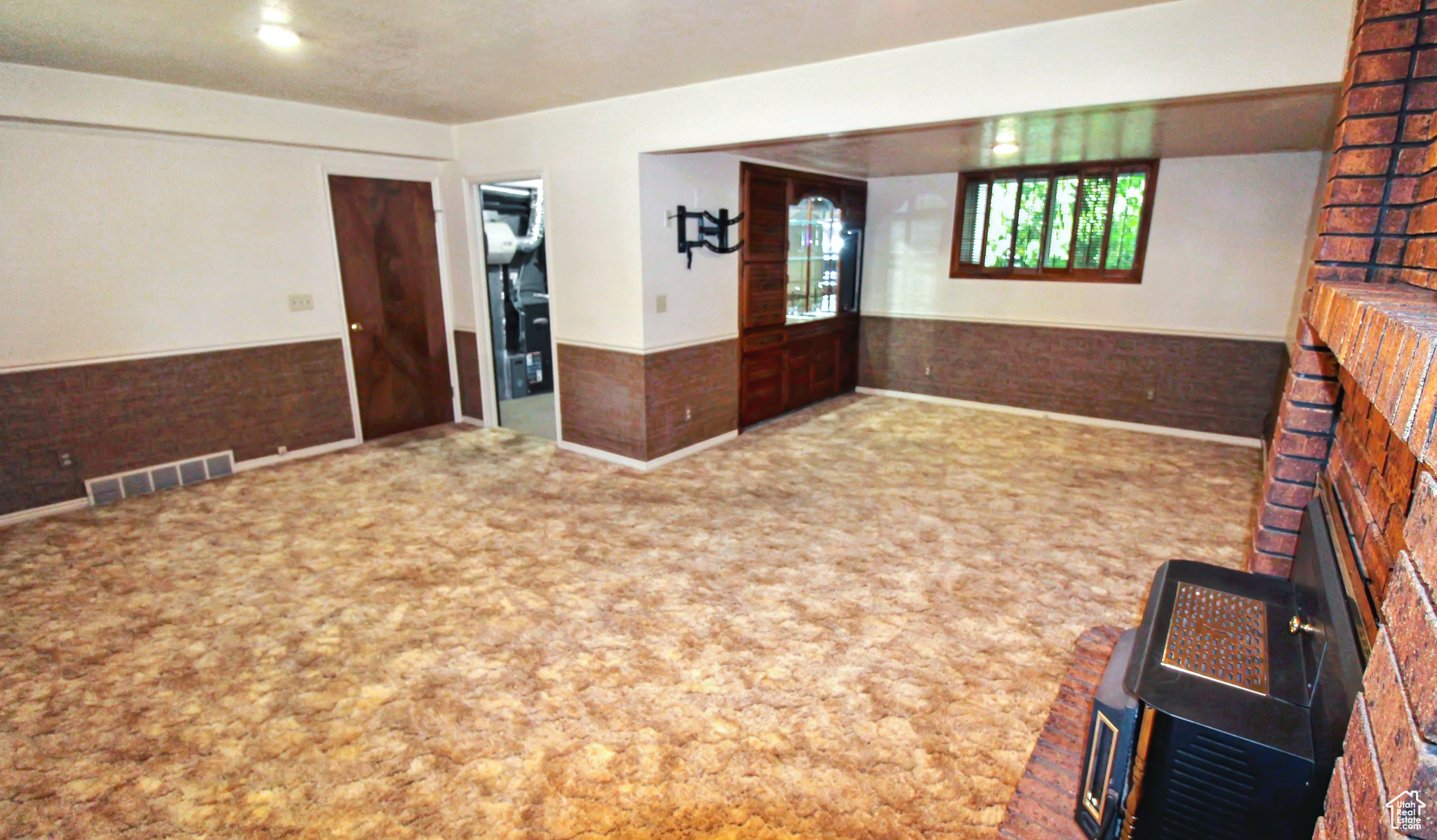 Family room with carpet and a fireplace