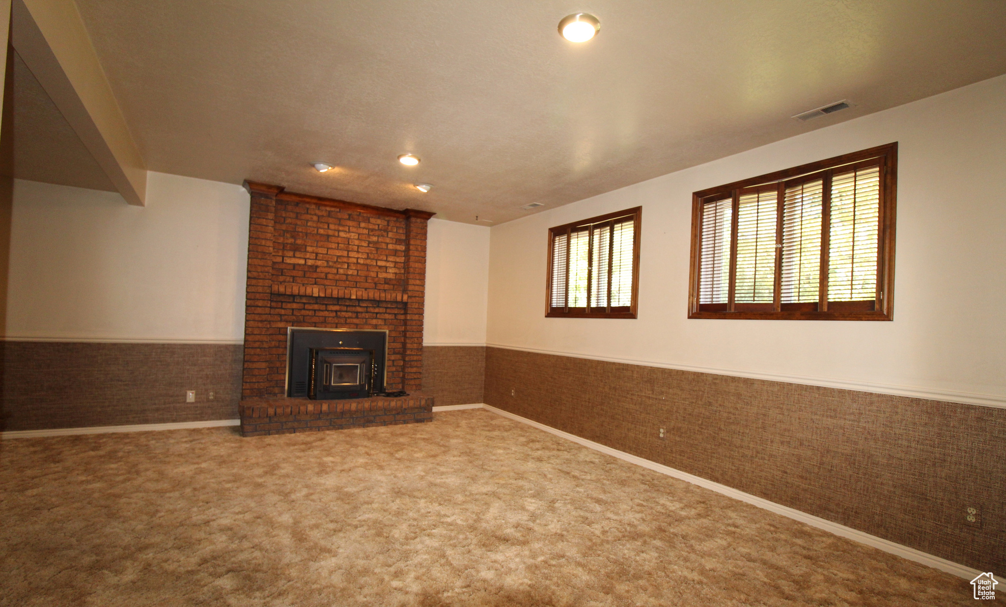 Family room with carpet and a fireplace