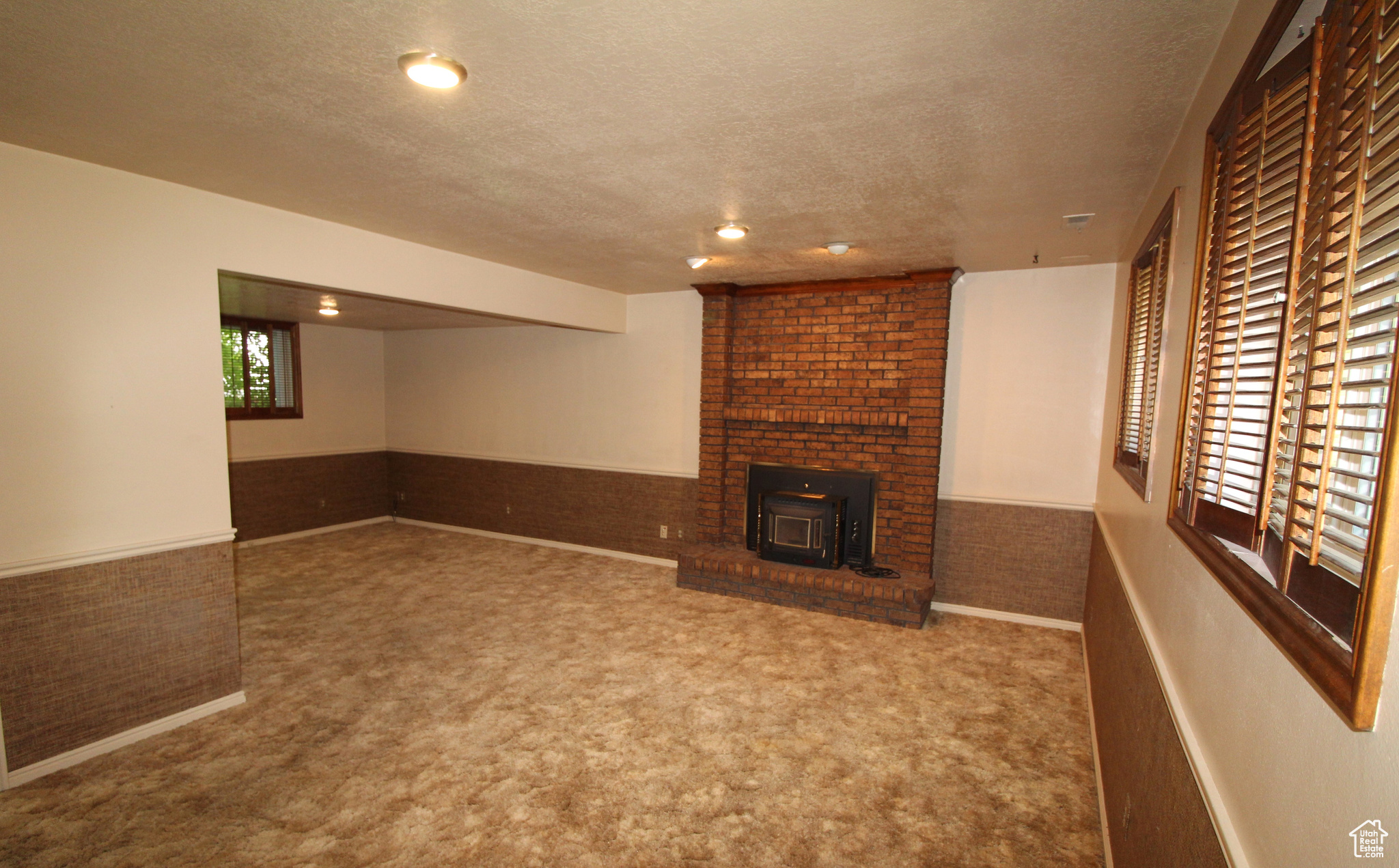 Family room with carpet and a fireplace