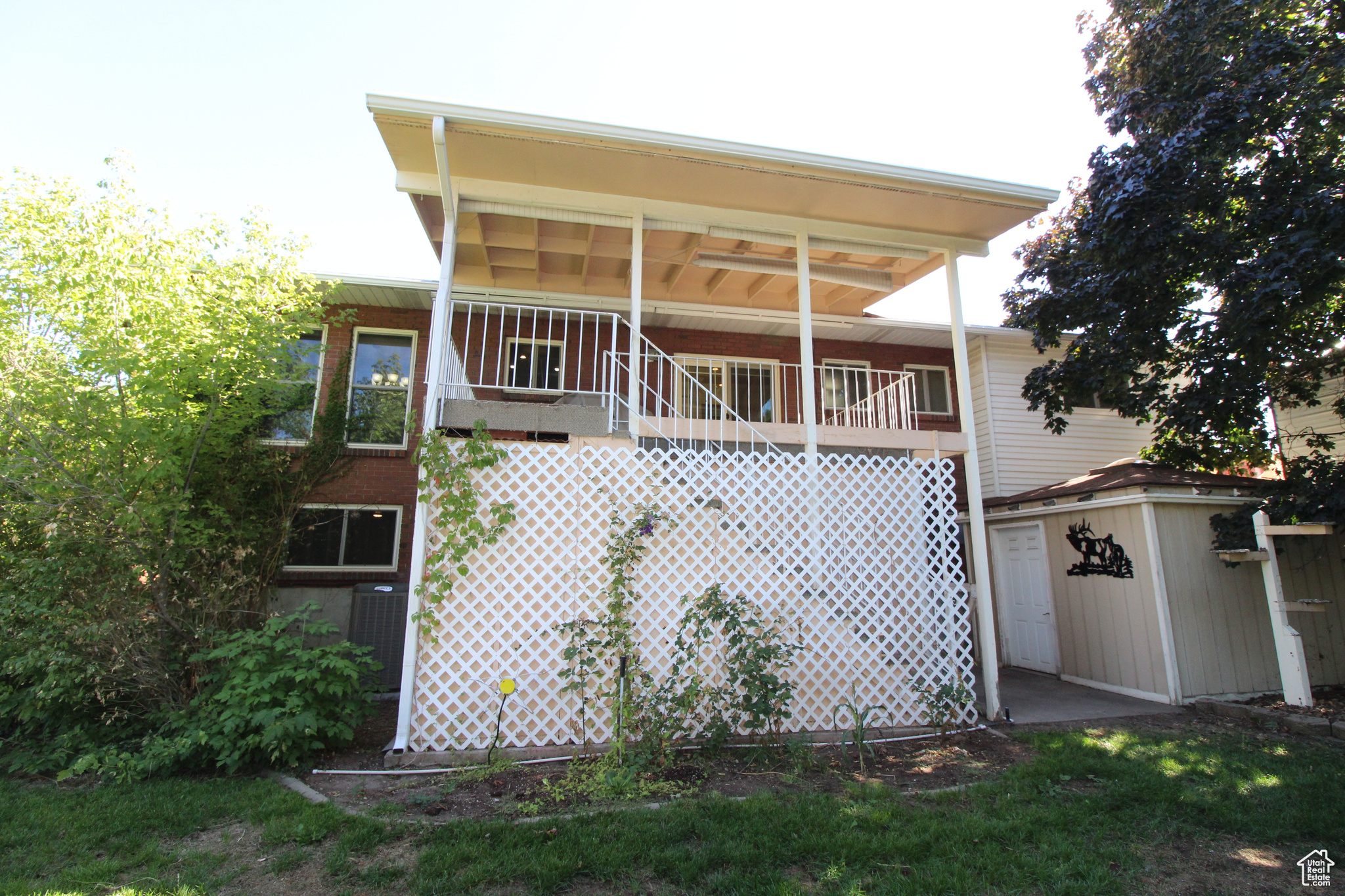 Exterior space with deck and a storage shed