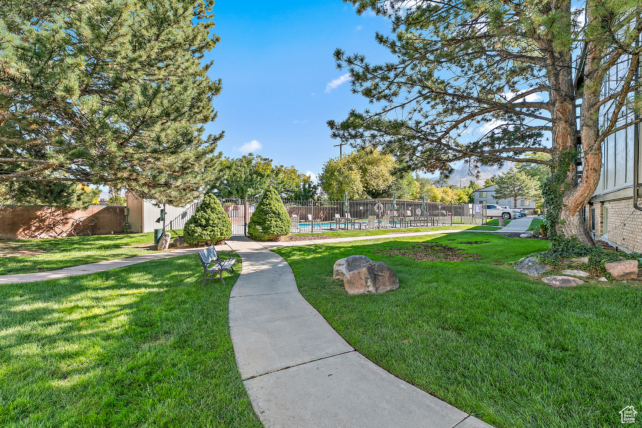 View of property's community featuring a pool and a yard