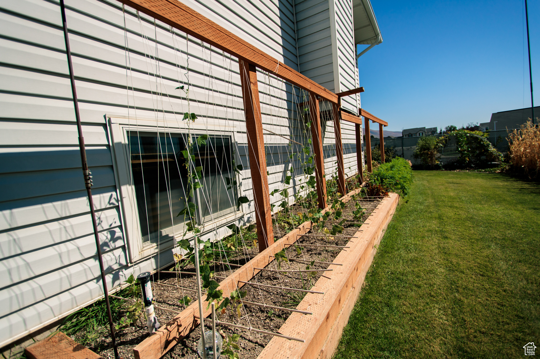 View of side of home featuring a lawn