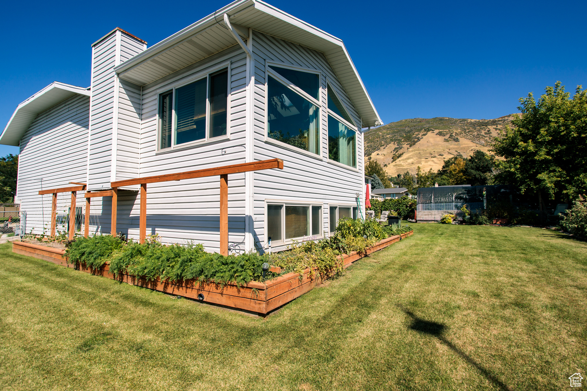 View of home's exterior featuring a mountain view and a yard