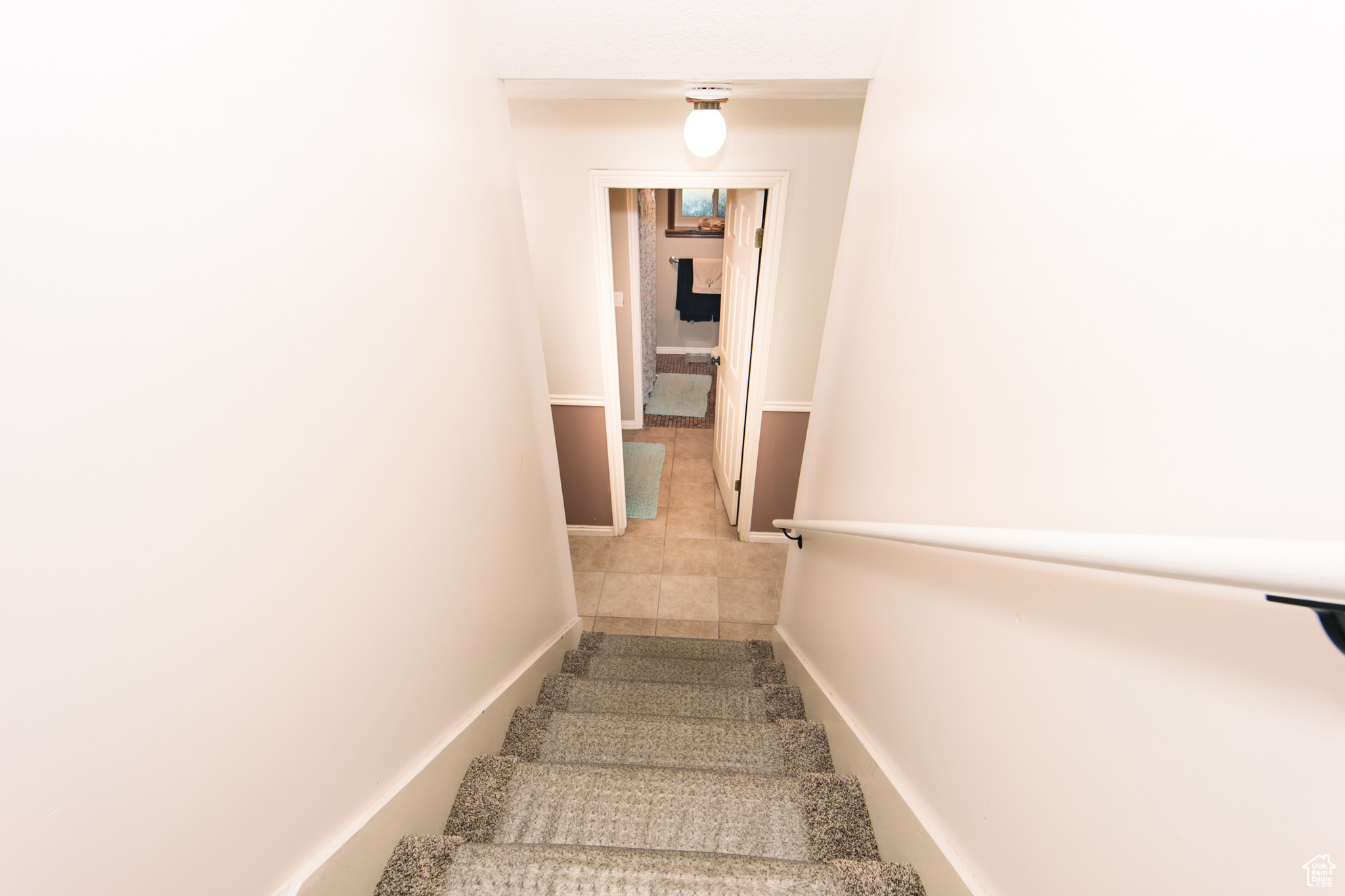 Stairs featuring tile patterned floors