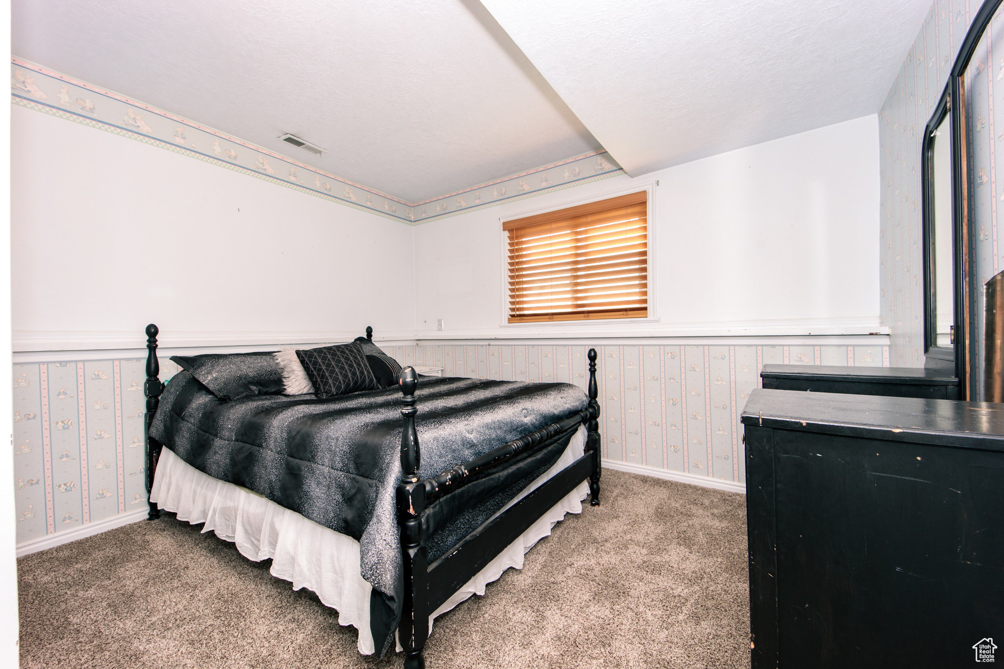 Carpeted bedroom with a textured ceiling