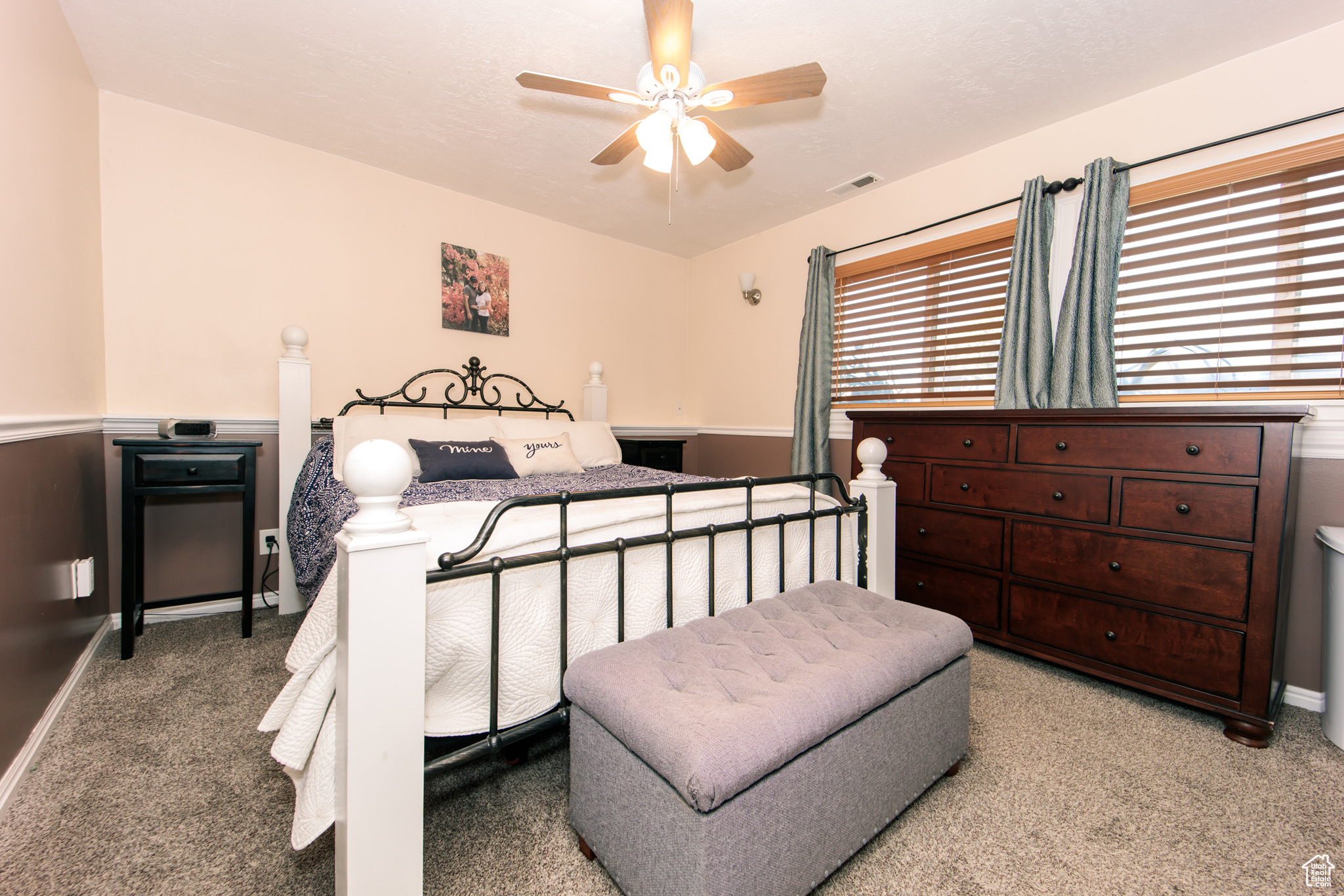 Bedroom with ceiling fan and light colored carpet