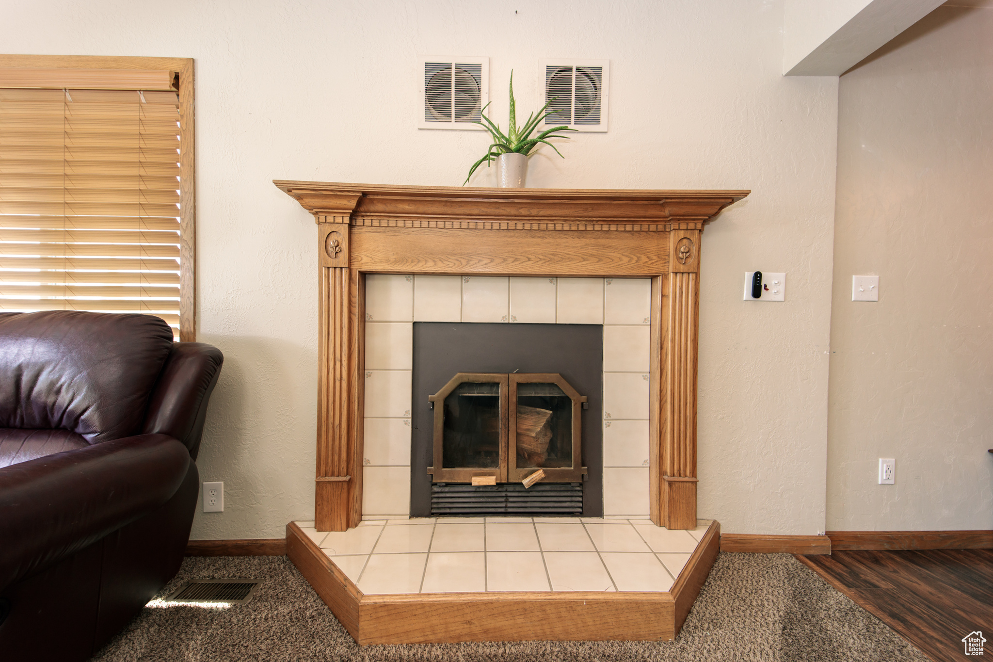 Details featuring a tile fireplace and hardwood / wood-style flooring