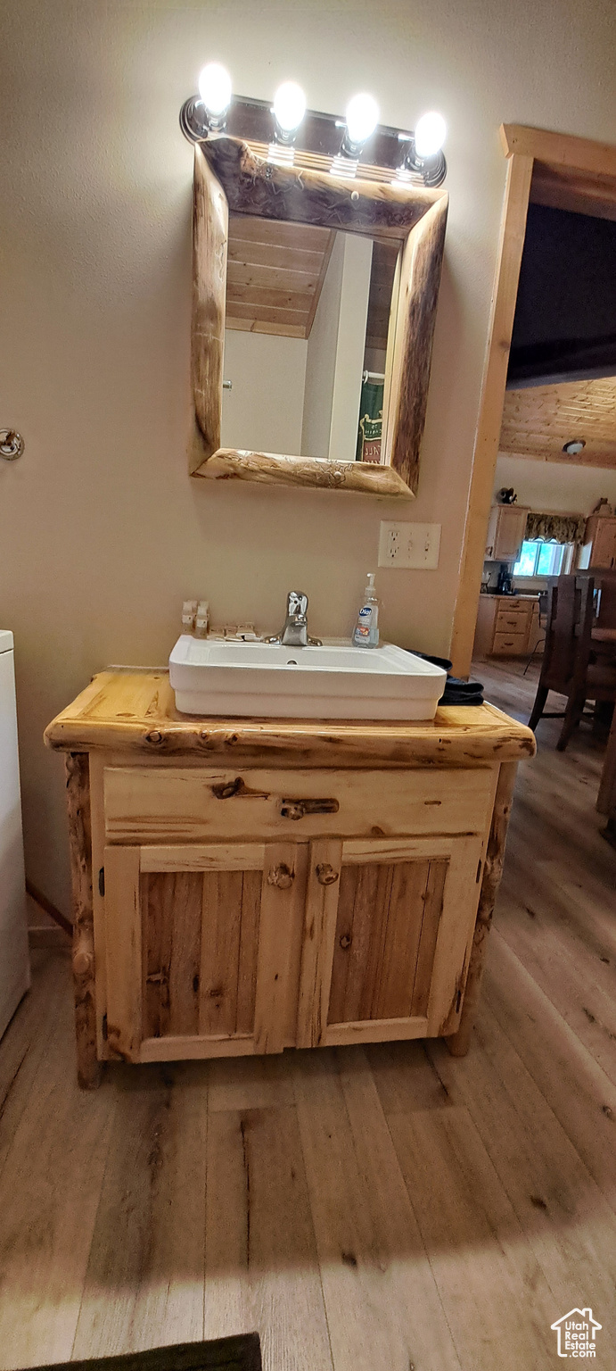 Bathroom with hardwood / wood-style flooring and vanity