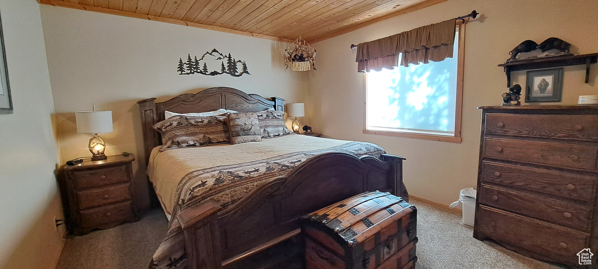 Bedroom featuring light colored carpet and wooden ceiling