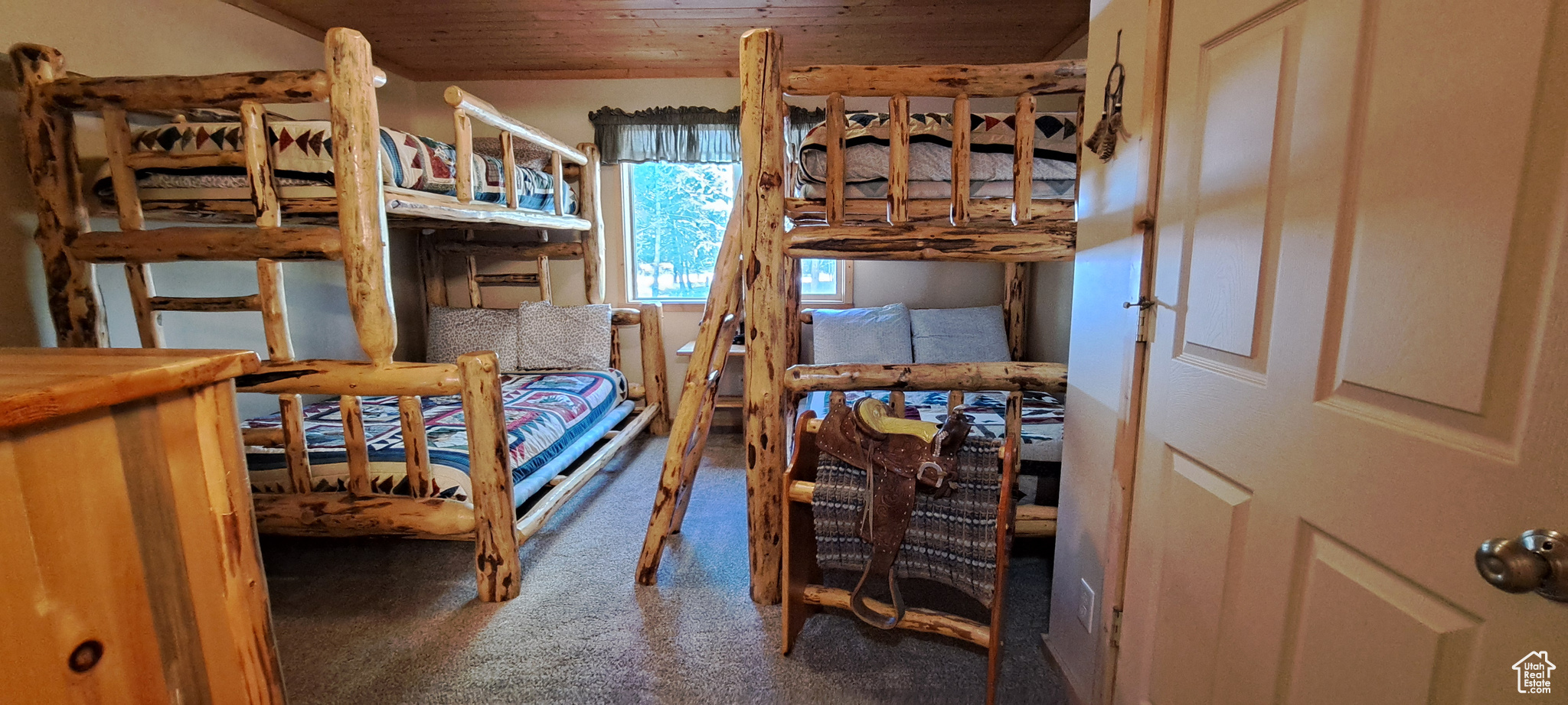 Bedroom featuring wooden ceiling and carpet floors