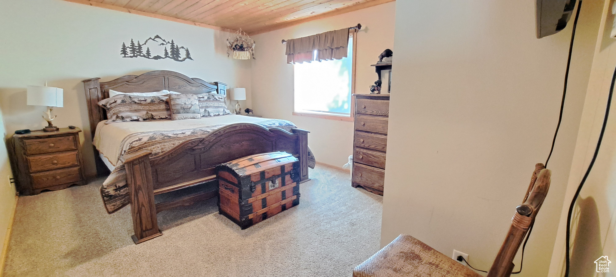 Bedroom featuring wood ceiling and light colored carpet