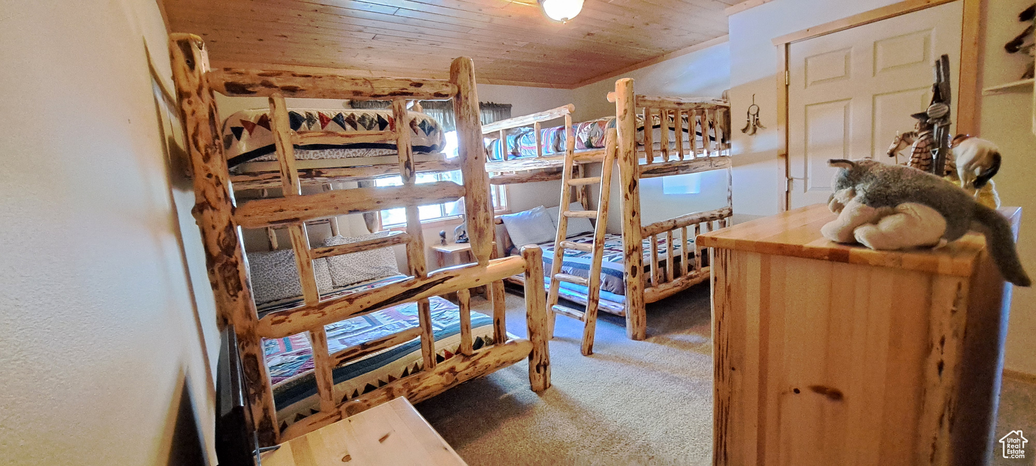 Carpeted bedroom featuring wood ceiling