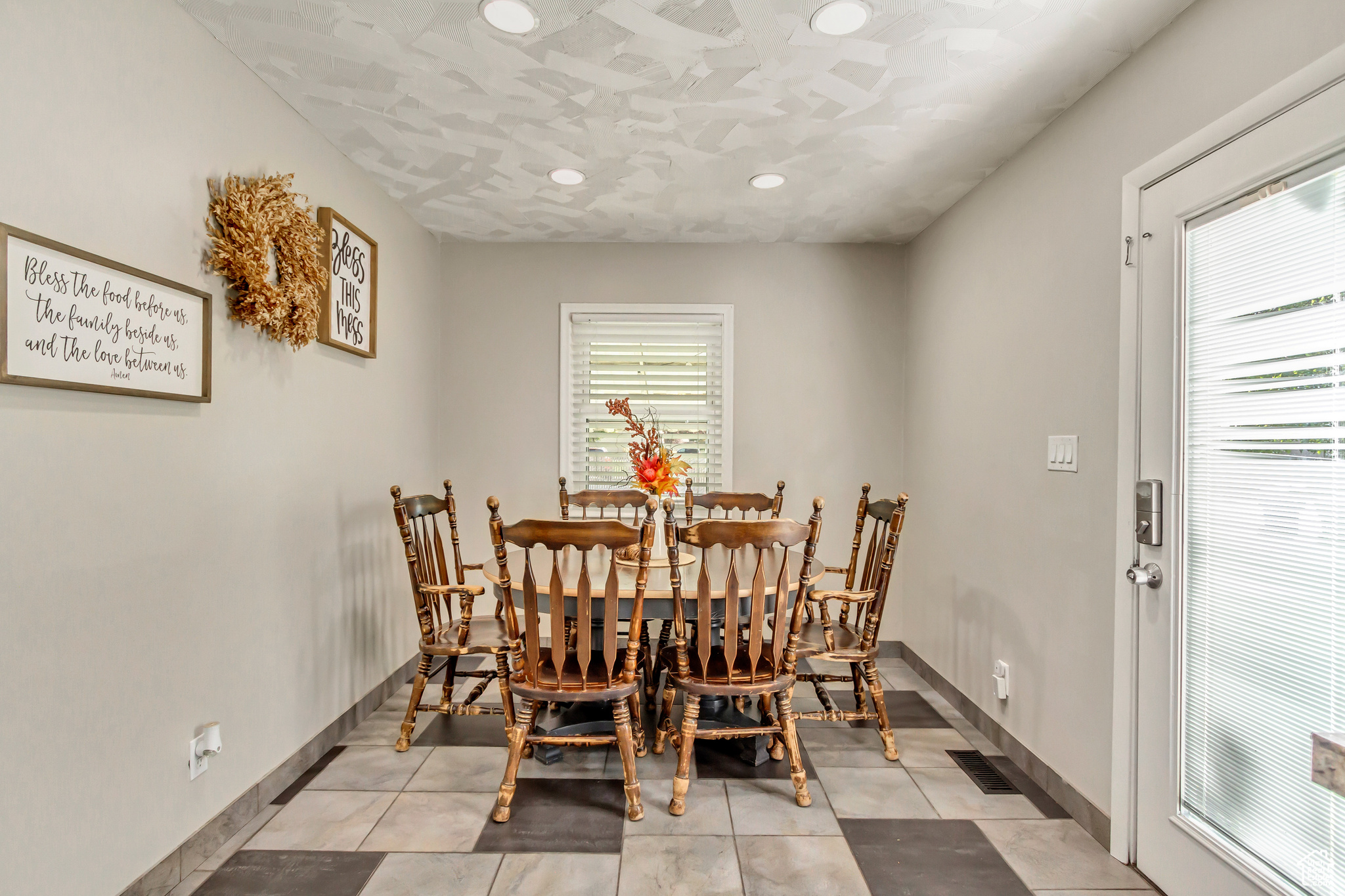 Tiled dining area featuring a wealth of natural light