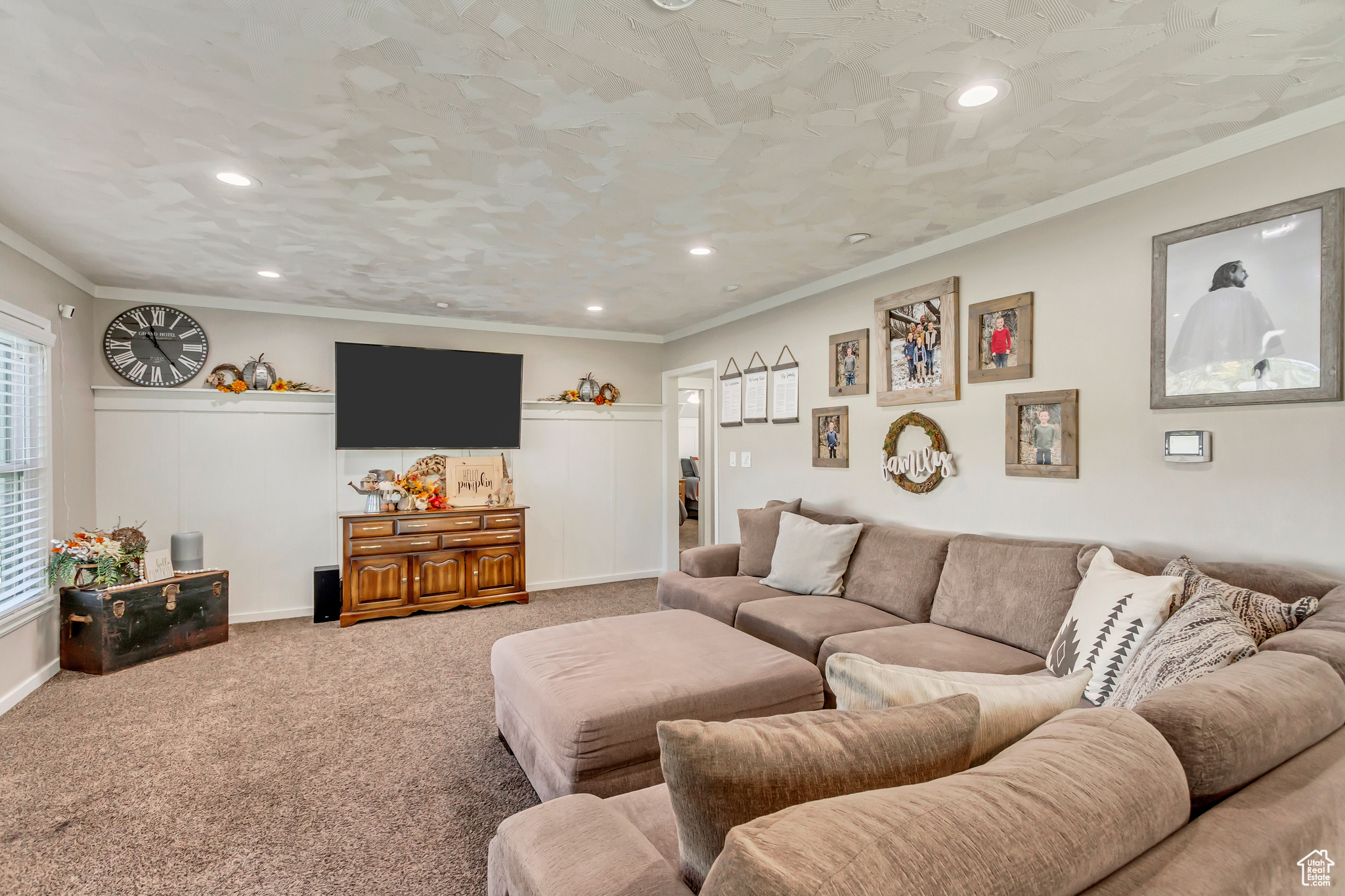 Carpeted living room with crown molding