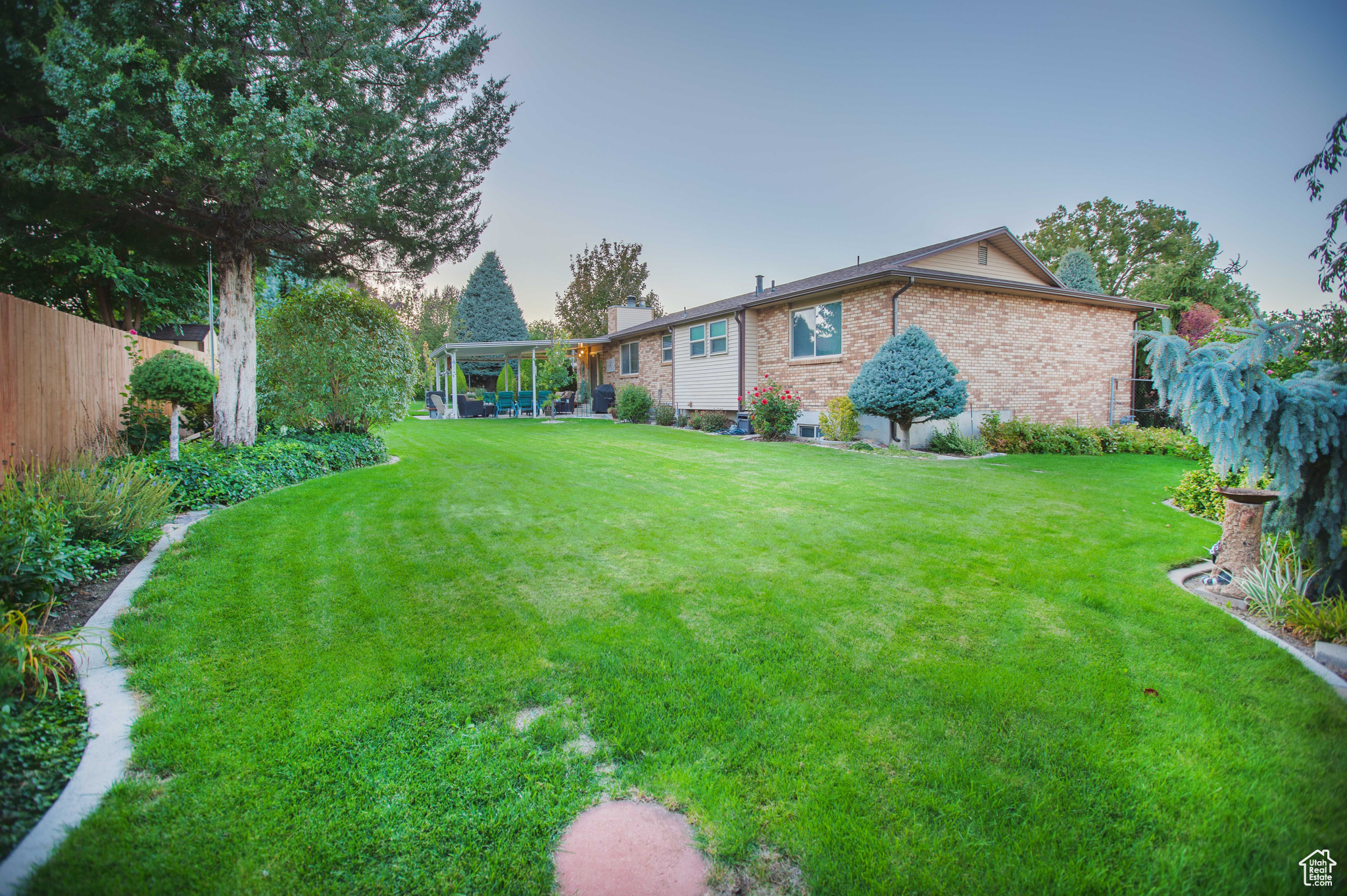 Large flat backyard with beautiful ornamental greenery.