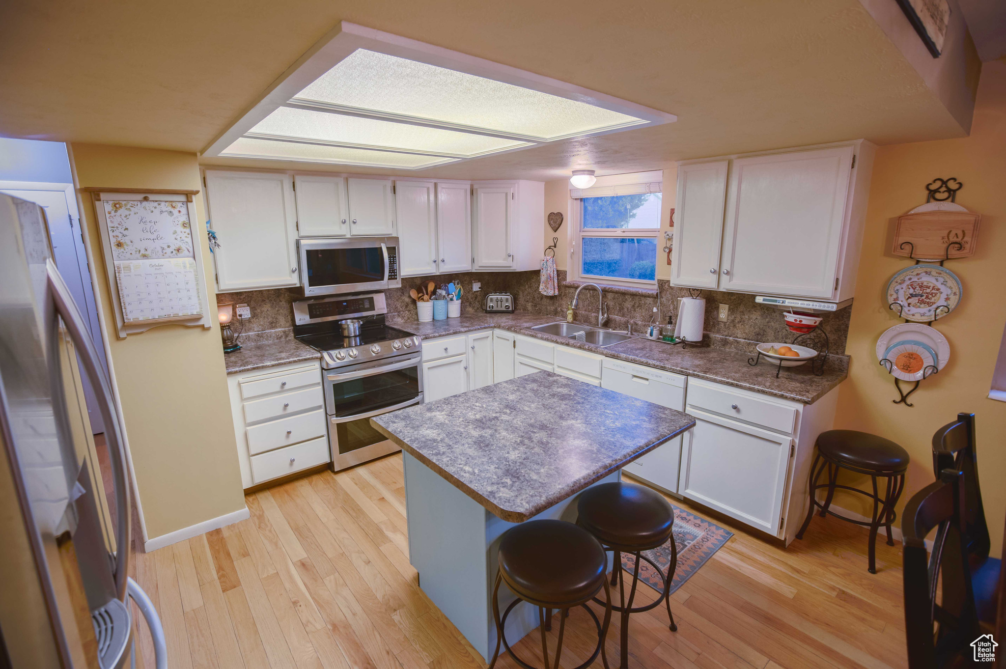 Open kitchen with real oak floors.