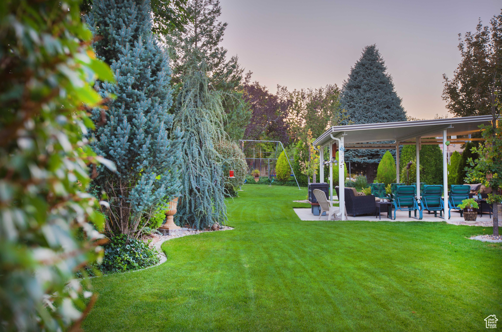 Large flat backyard with beautiful ornamental greenery.