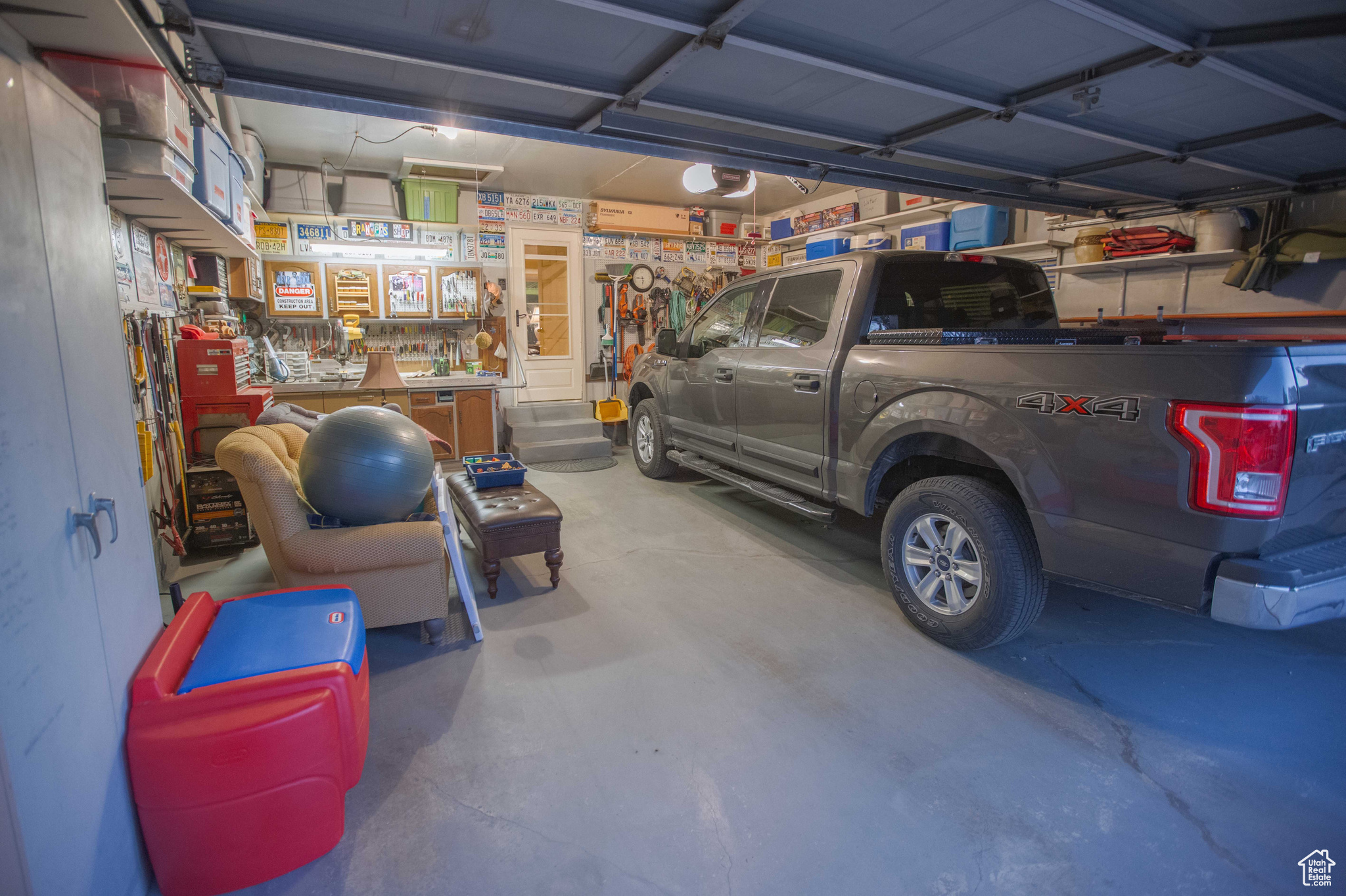 Spacious garage with work bench.