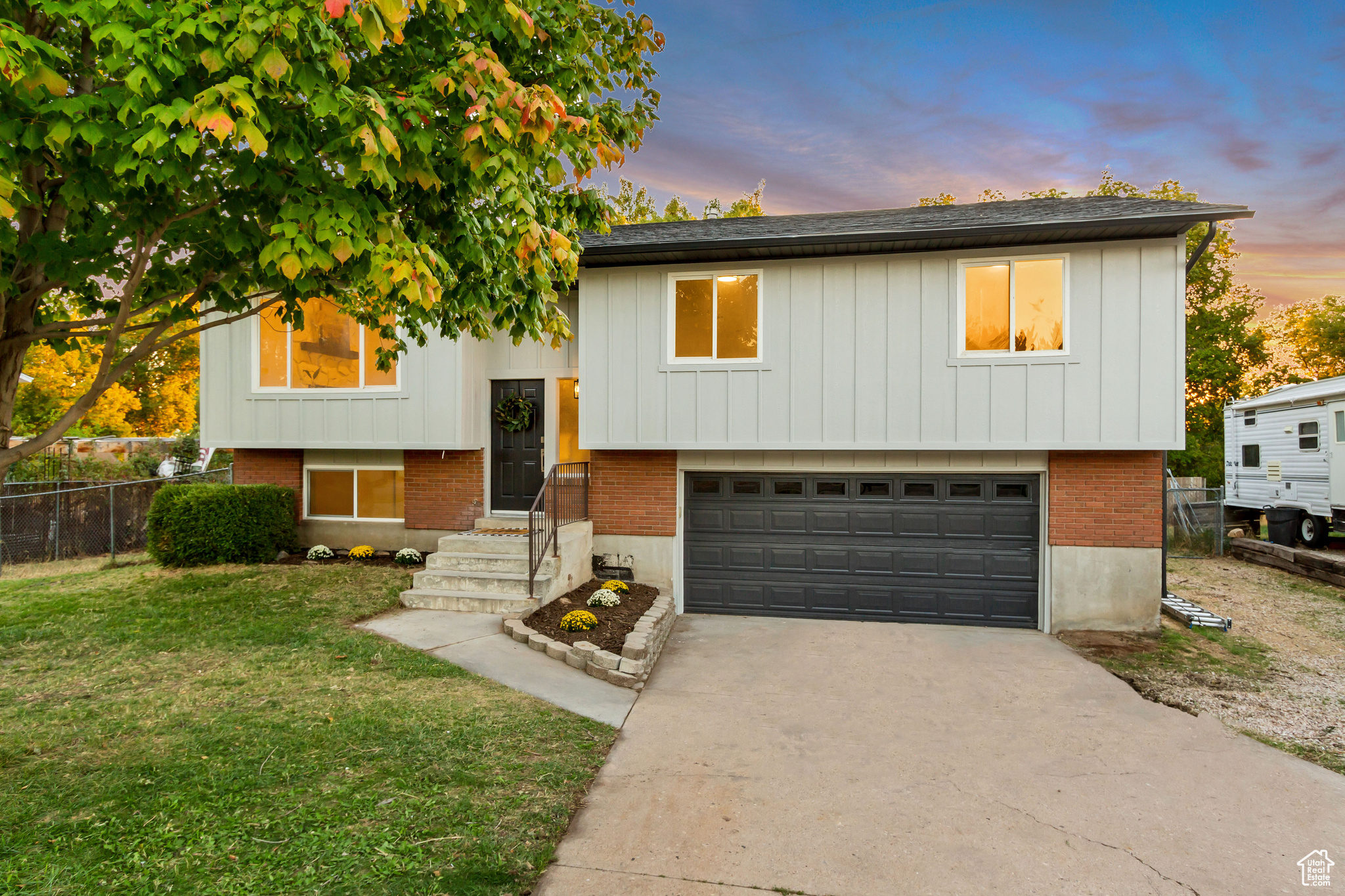 Split foyer home with a garage and a yard