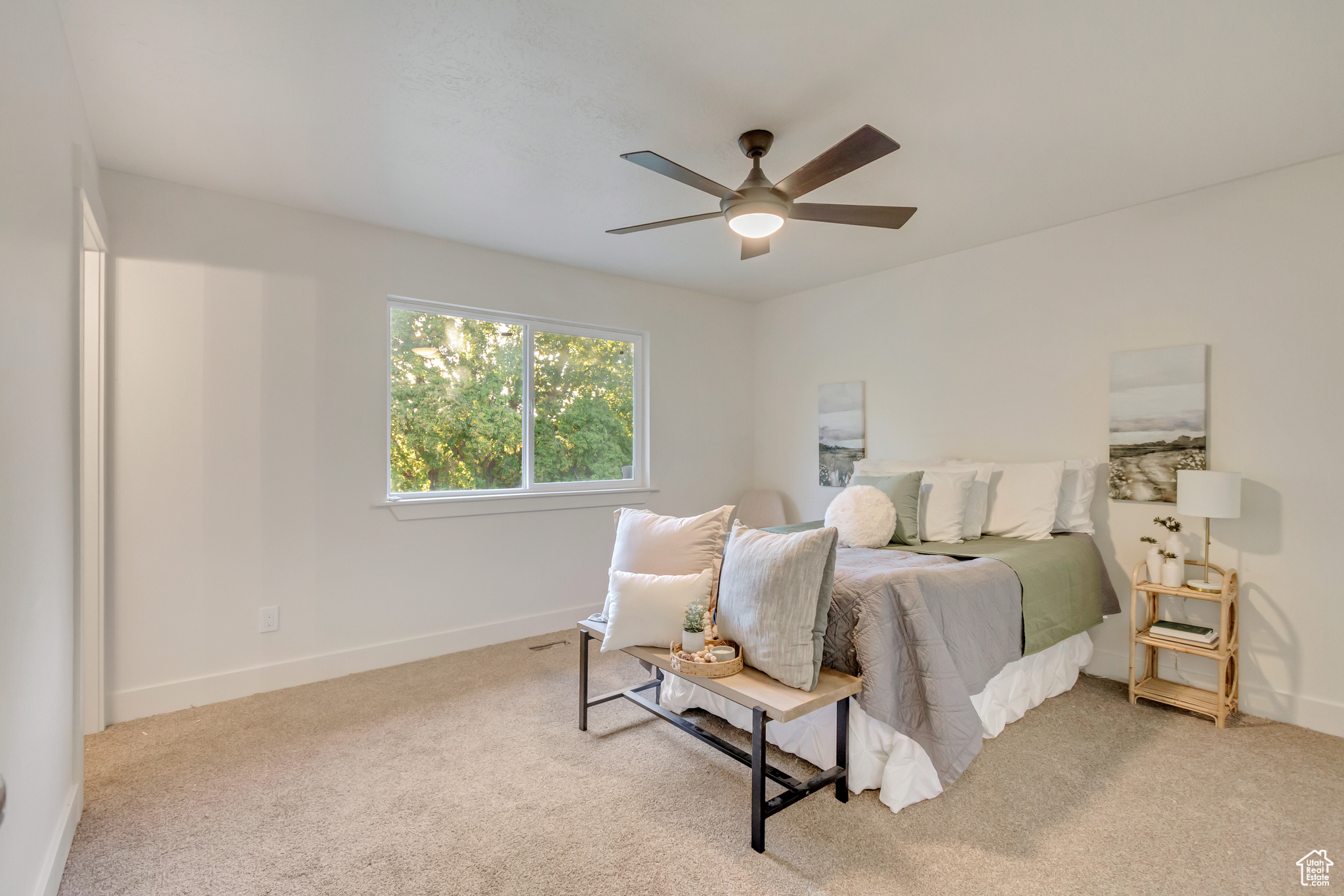 Carpeted bedroom featuring ceiling fan