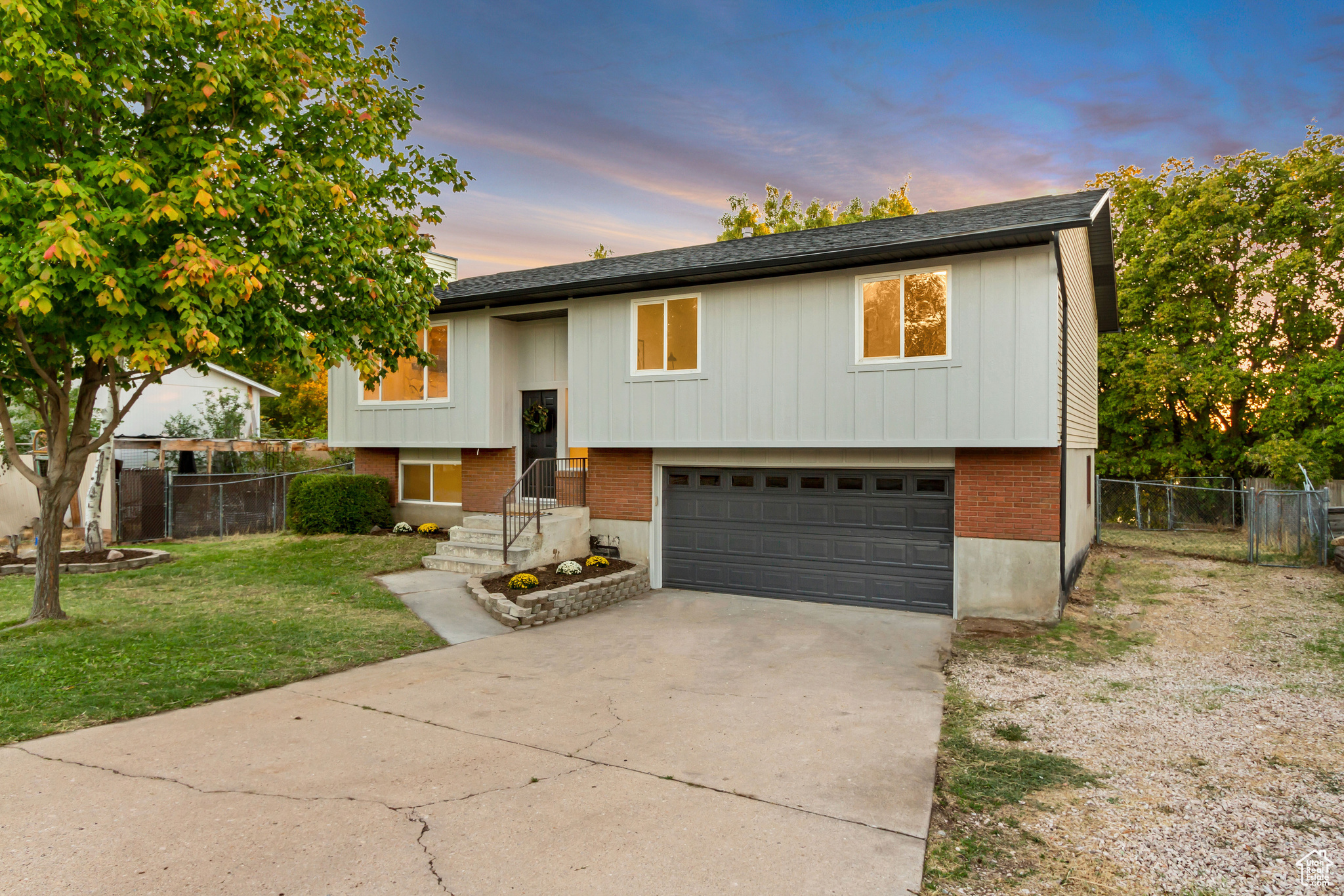 Raised ranch with a garage and a lawn