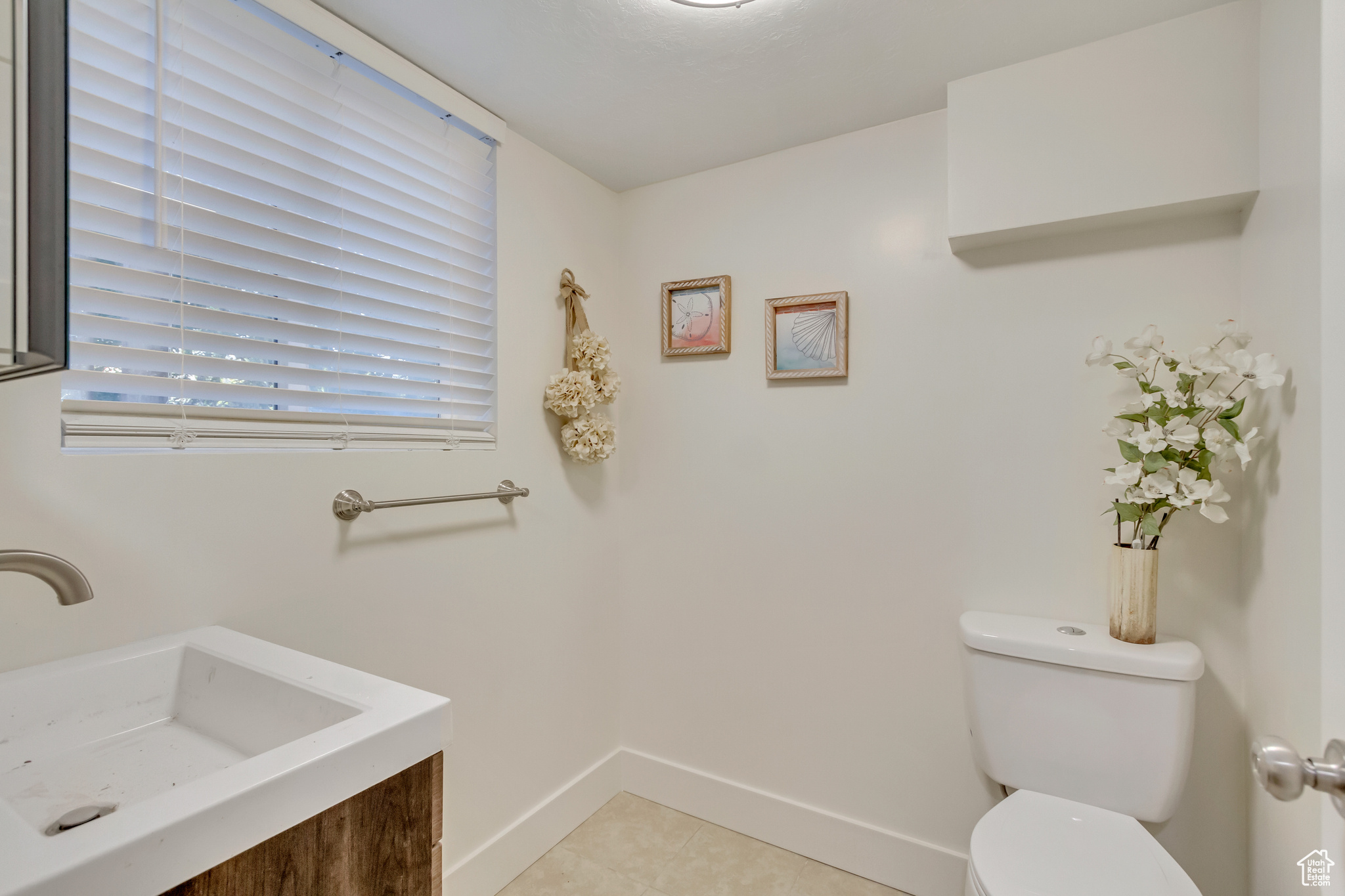 Bathroom featuring tile patterned flooring, vanity, and toilet