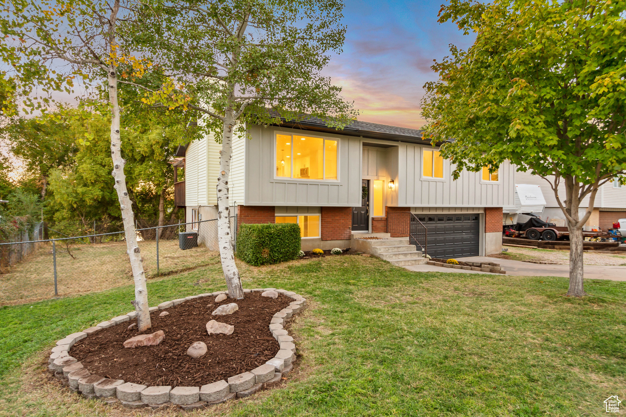 Raised ranch featuring a yard and a garage