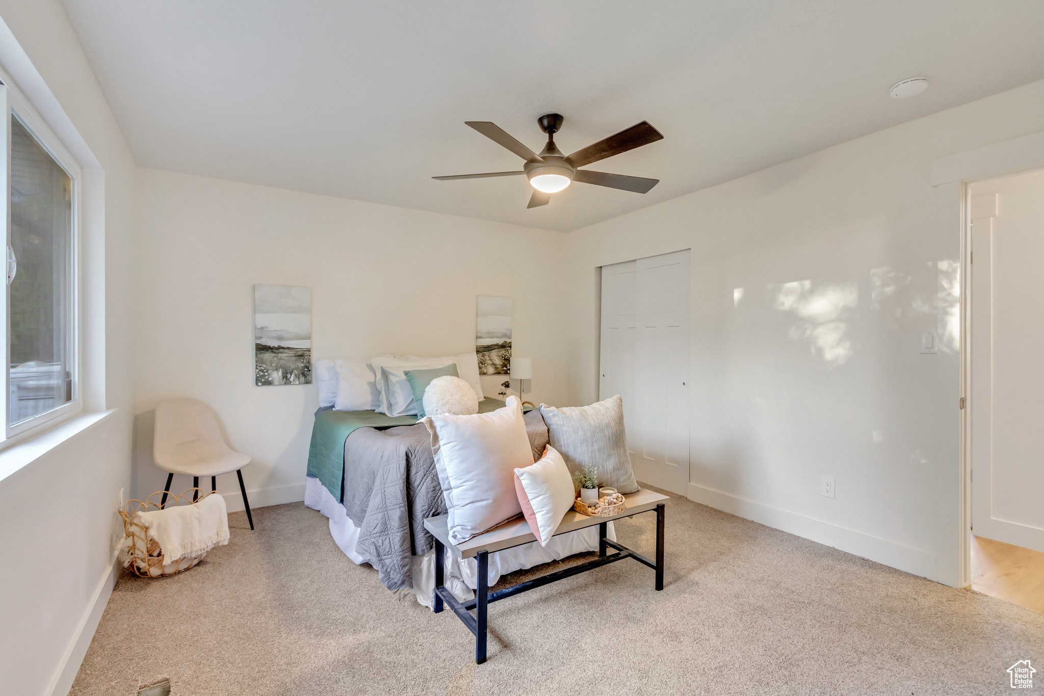 Carpeted bedroom with a closet and ceiling fan