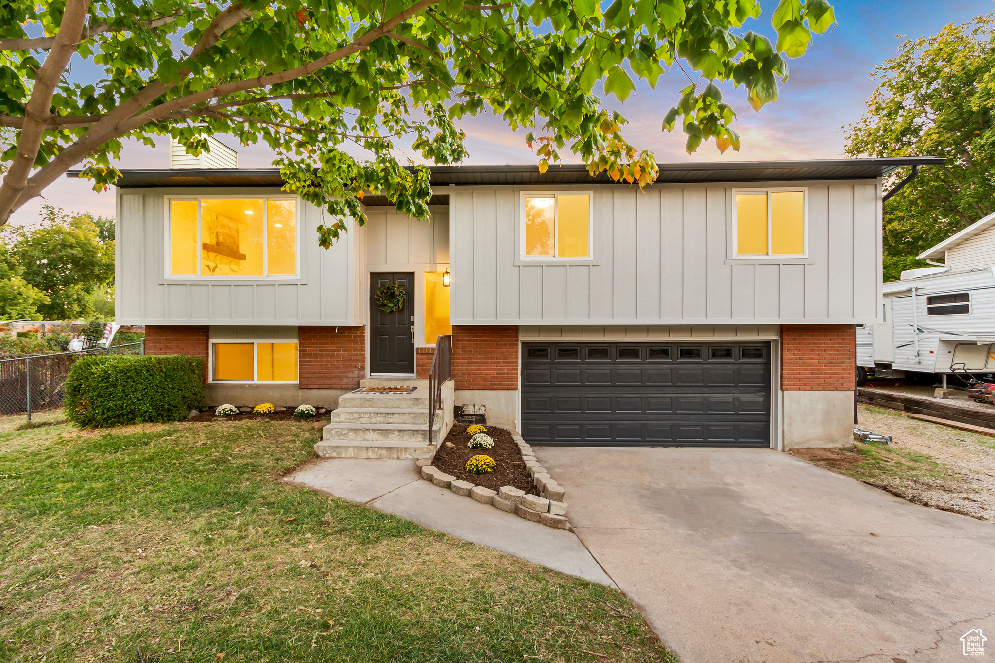 Bi-level home with a lawn and a garage